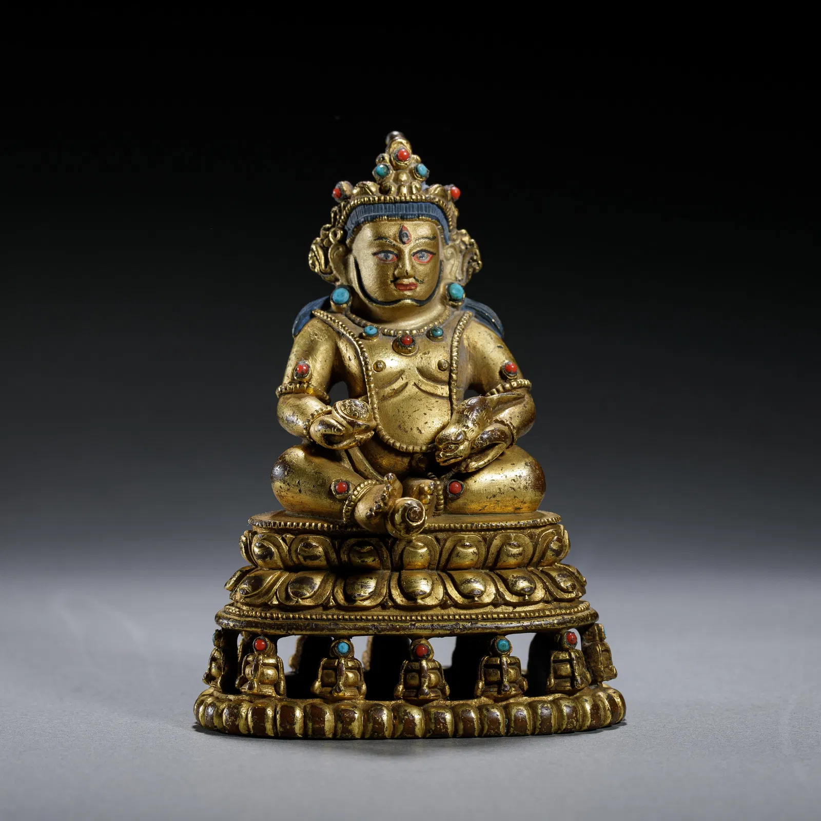 A BRONZE-GILT FIGURE OF JAMBHALA