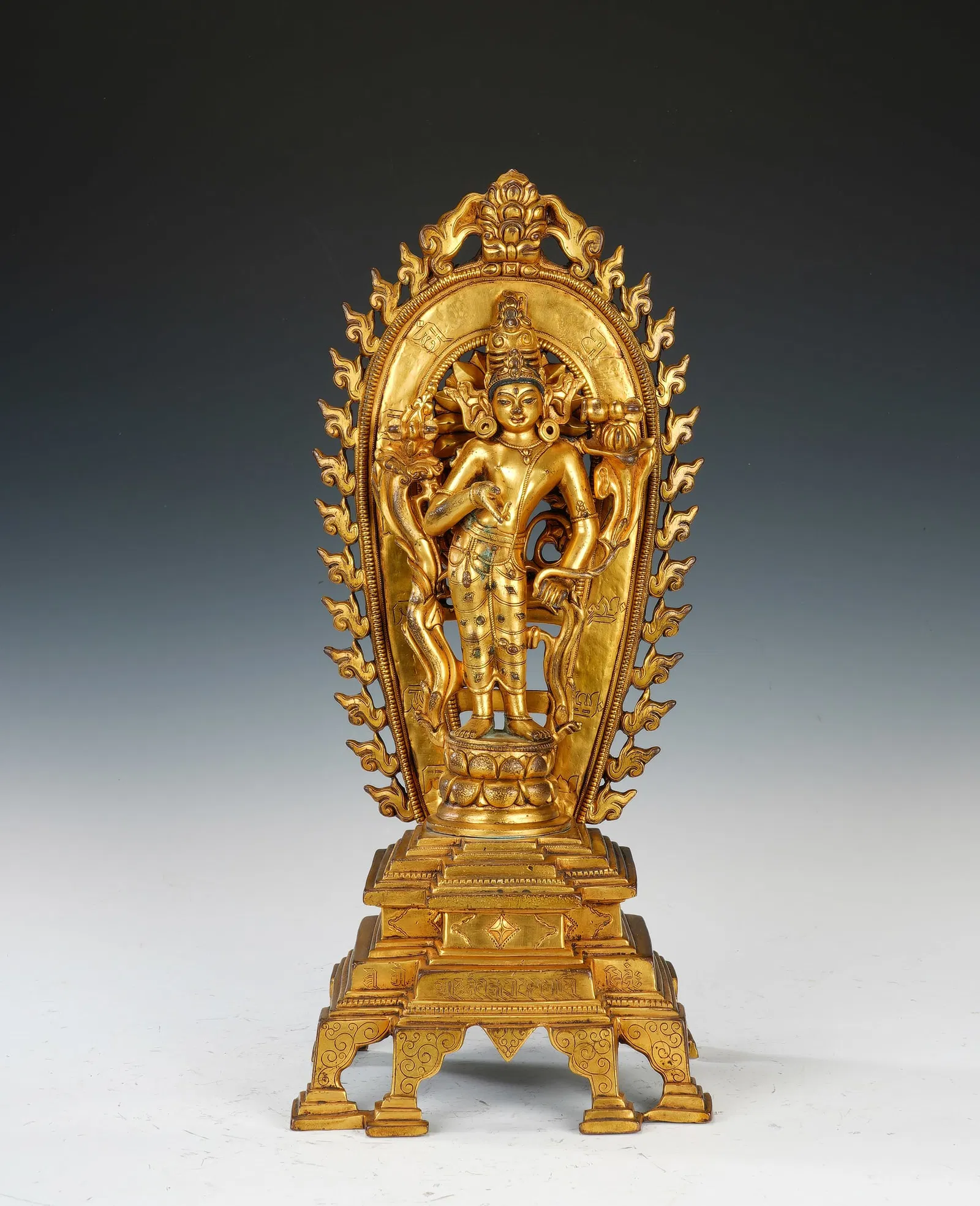 A BRONZE-GILT STANDING PADMAPANI