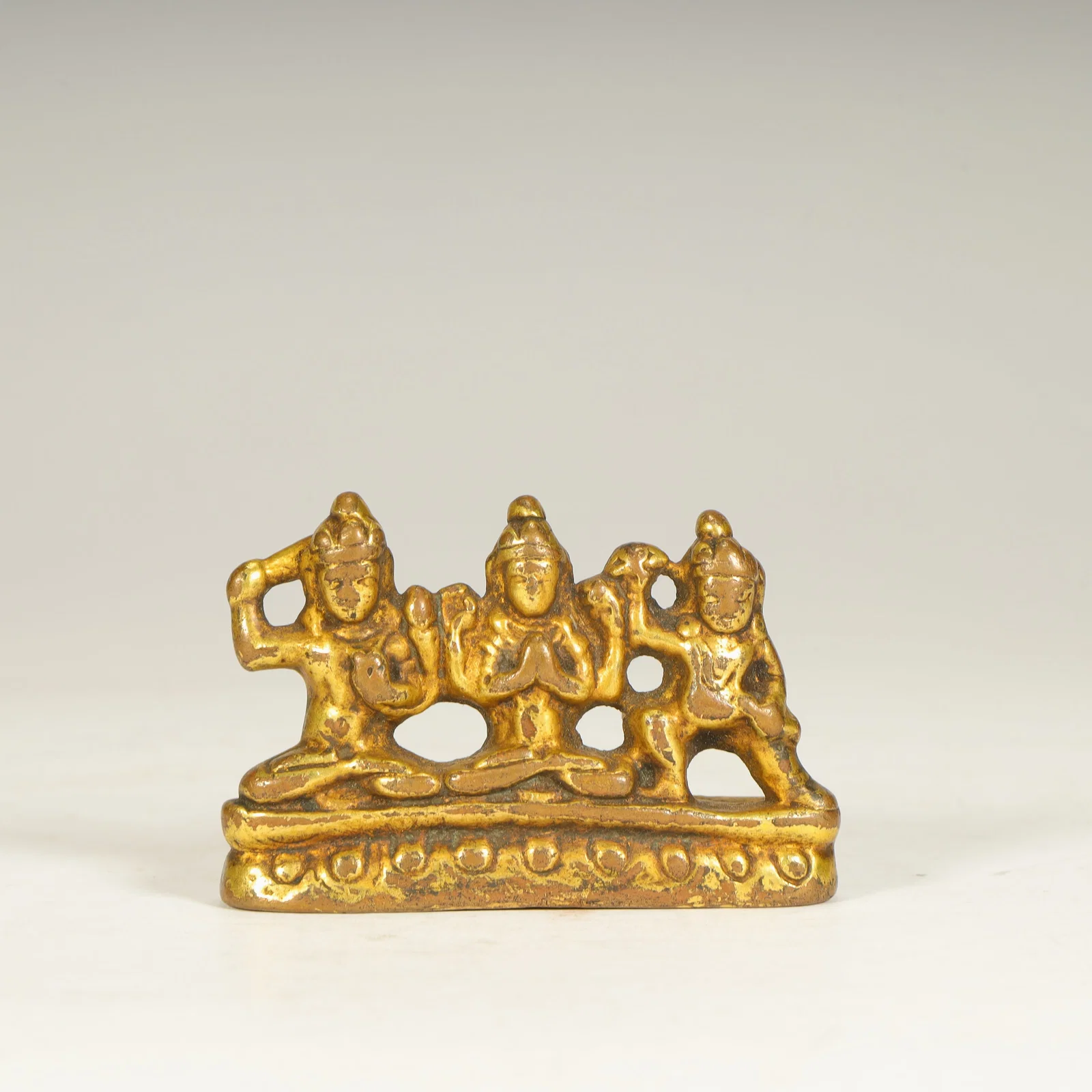 A bronze gilt statue of a Buddha and two sides in the Tang Dynasty