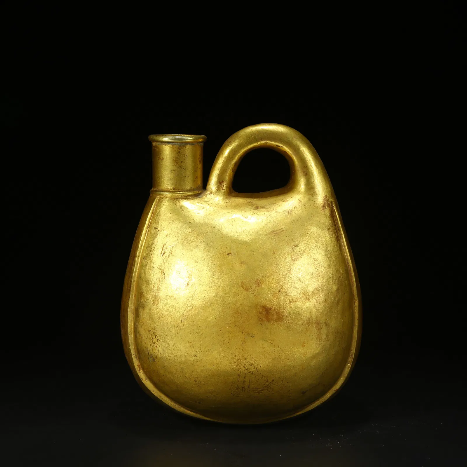 A BRONZE GILT WINESKIN-SHAPED EWER