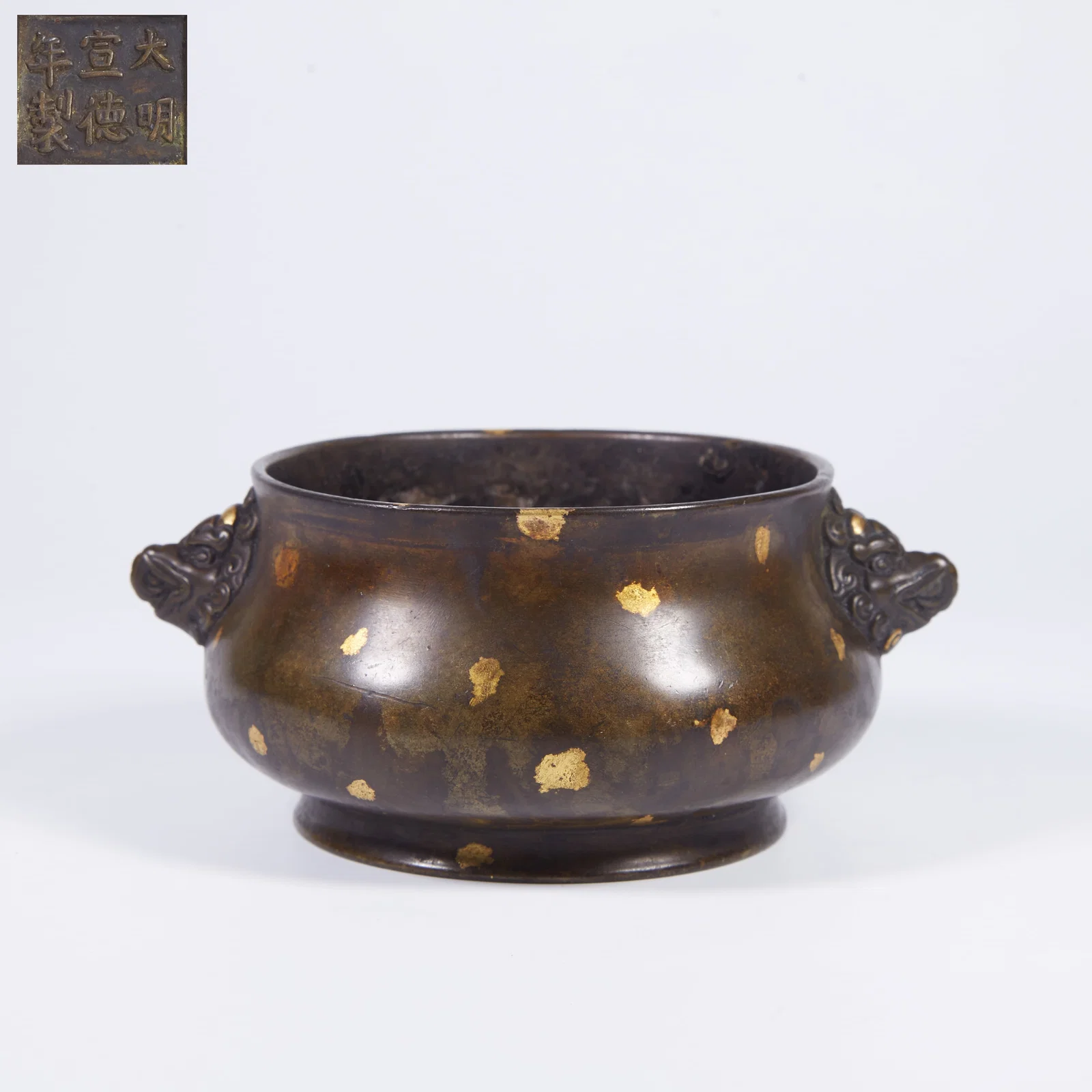 A BRONZE INCENSE BURNER WITH BEAST-MASK HANDLES