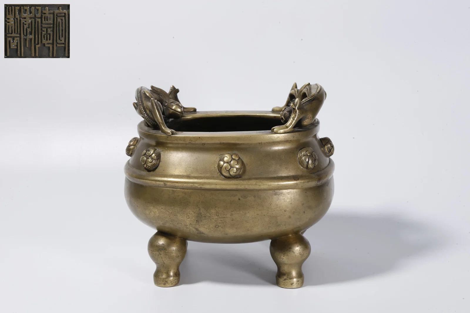 A BRONZE INCENSE BURNER WITH DOUBLE DRAGON HANDLES