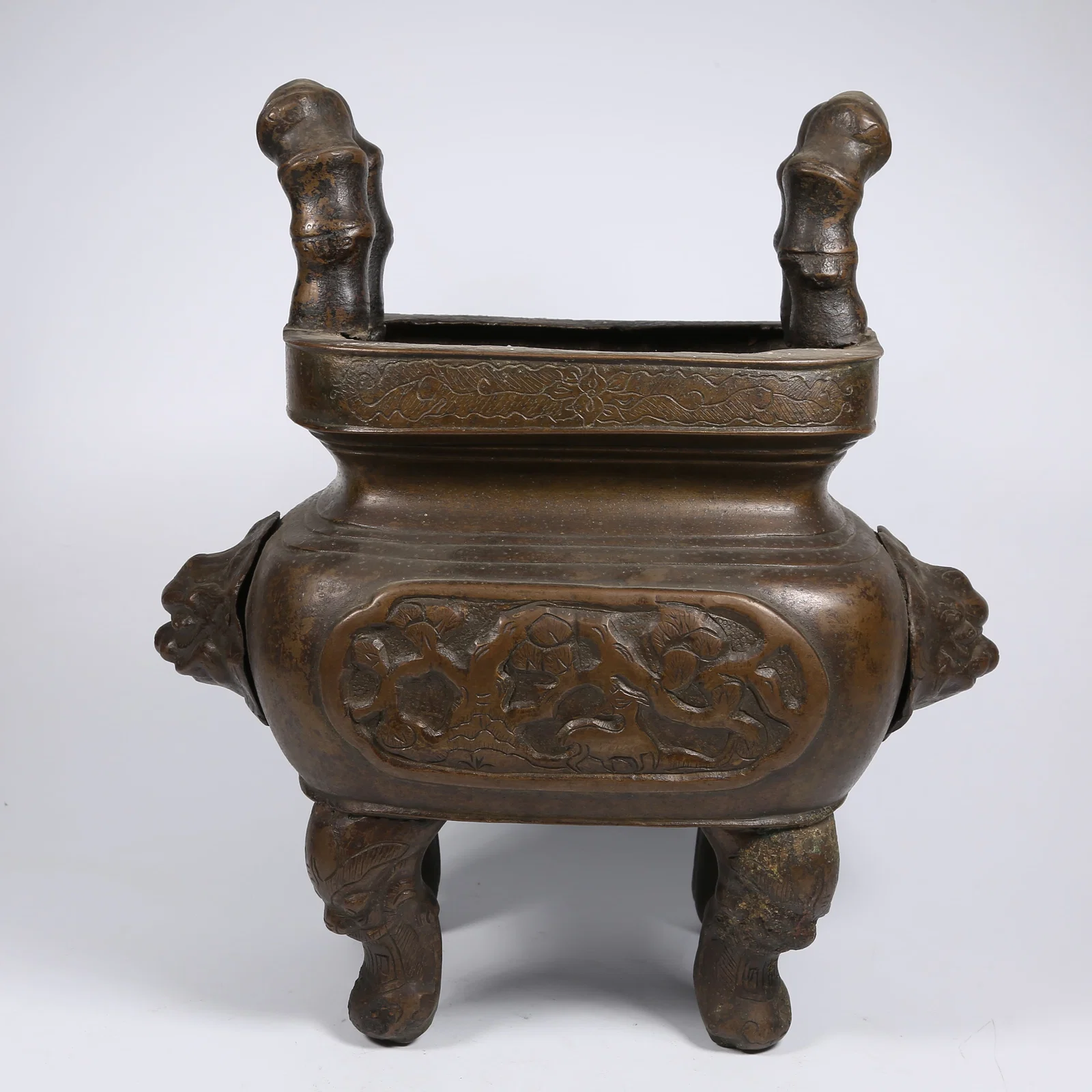 A BRONZE INCENSE BURNER WITH LION EARS