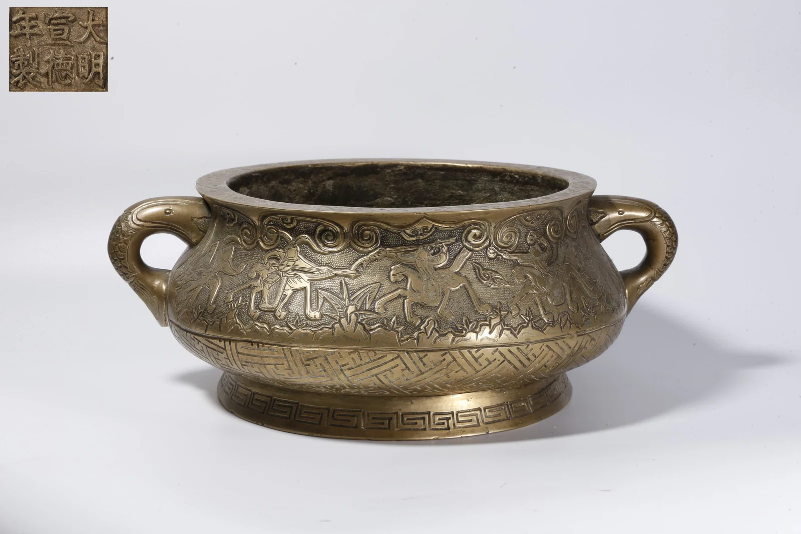 A BRONZE INCENSE BURNER WITH TWIN HANDLES AND FIGURAL NARRATIVE MOTIF
