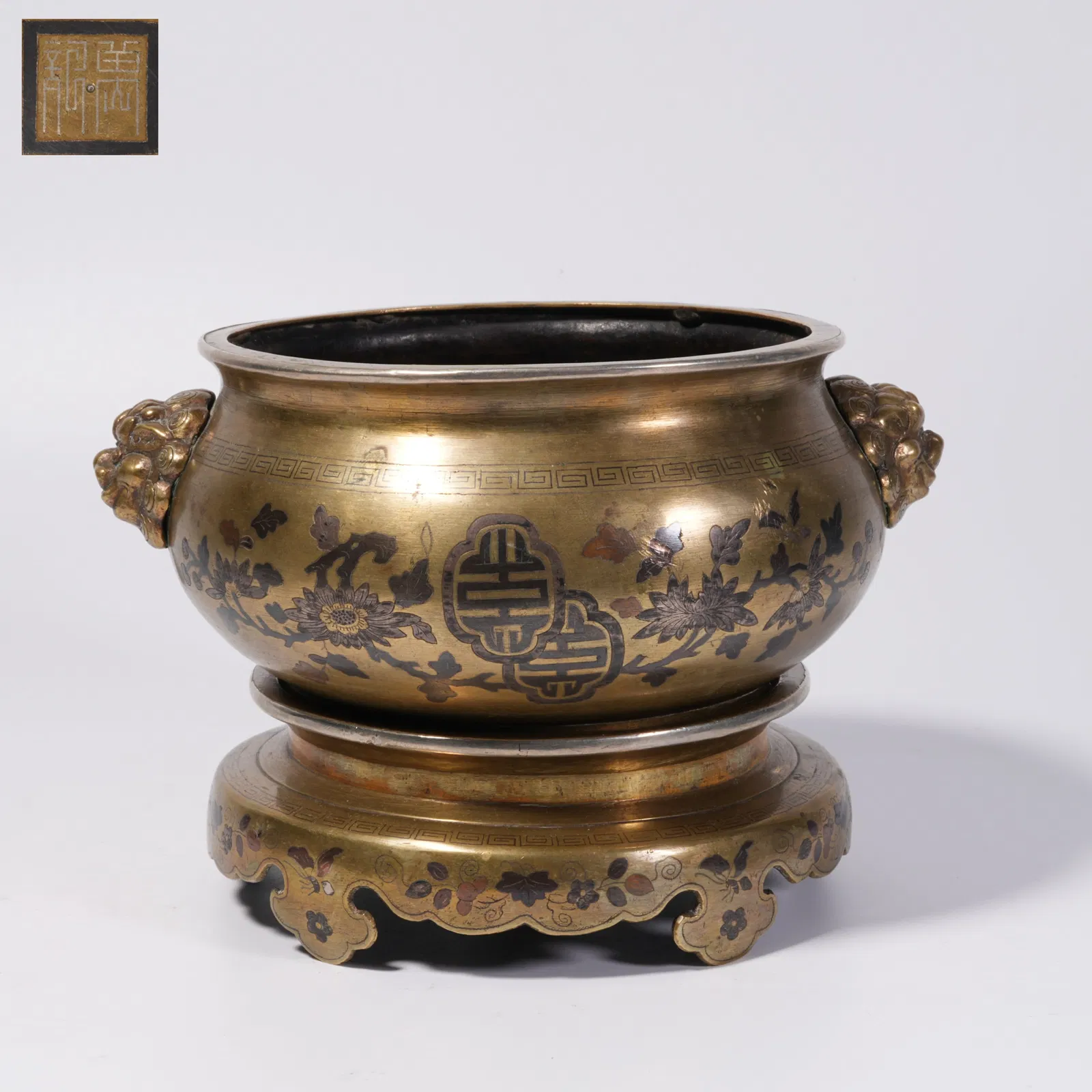 A BRONZE LION-HANDLED CENSER WITH BASE