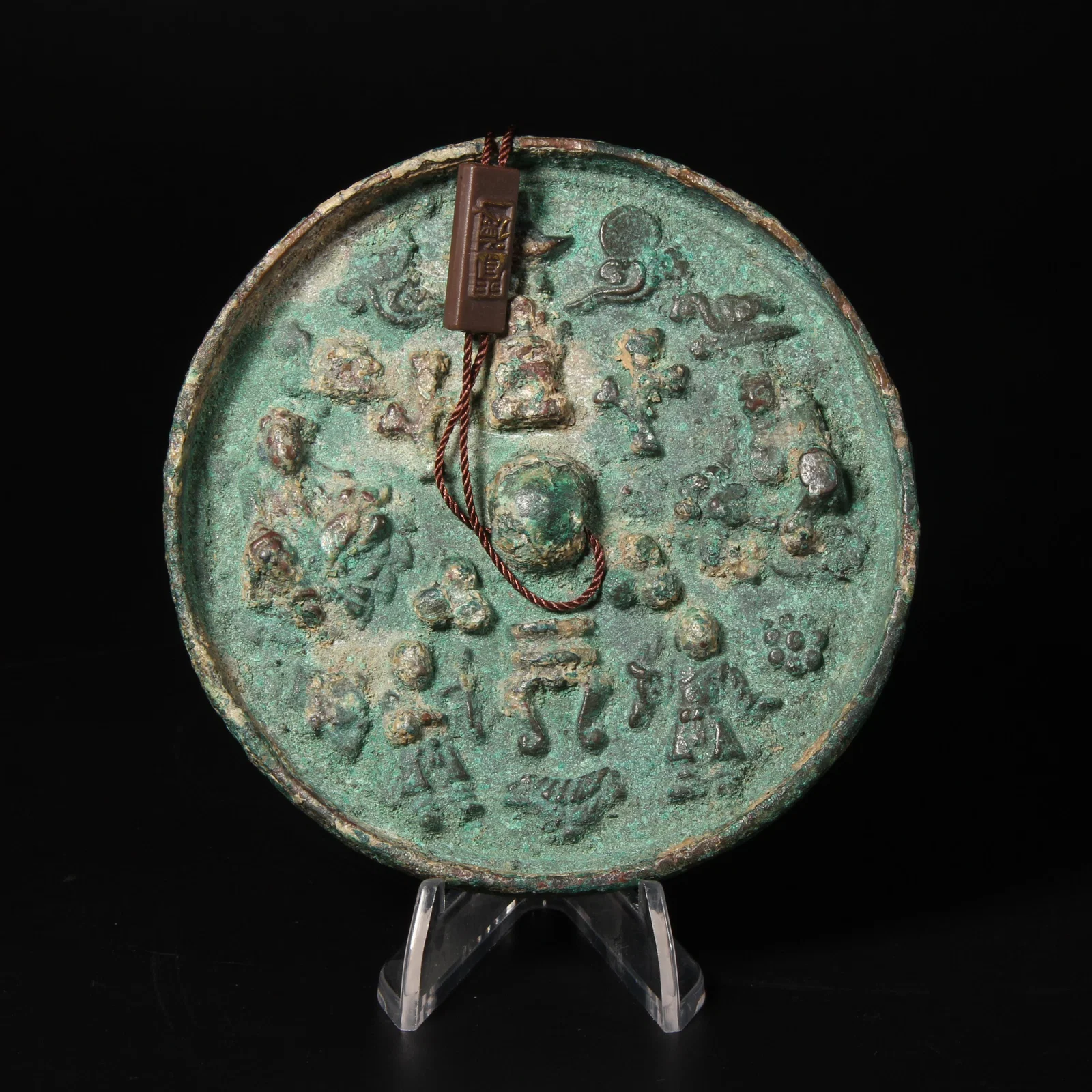 A BRONZE MIRROR WITH FIGURAL AND TREASURE MOTIFS
