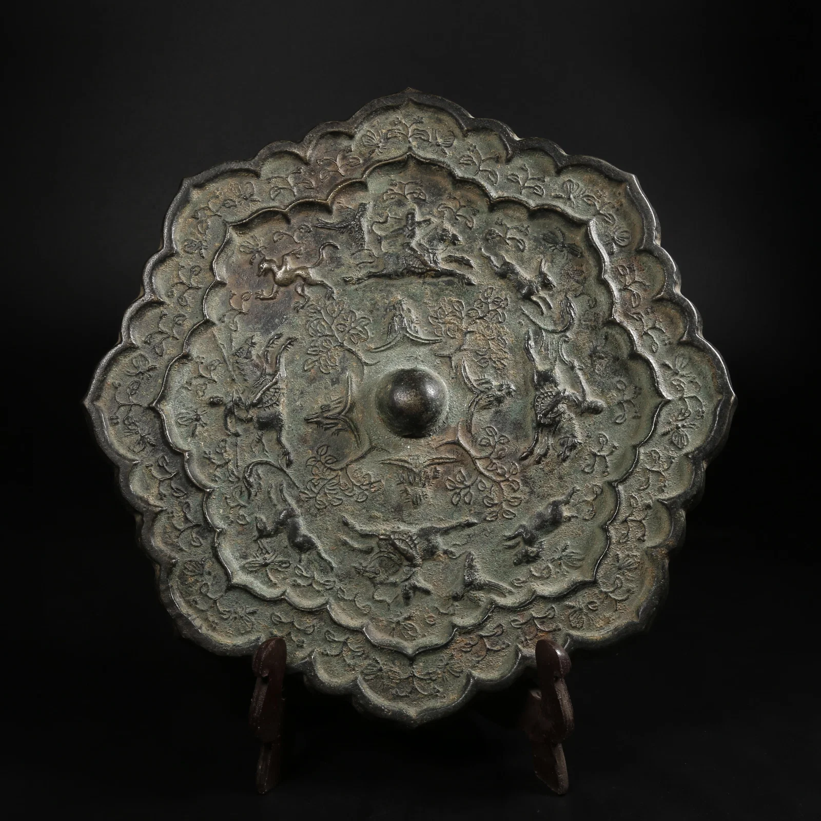 A BRONZE MIRROR WITH HUNTING SCENE MOTIF
