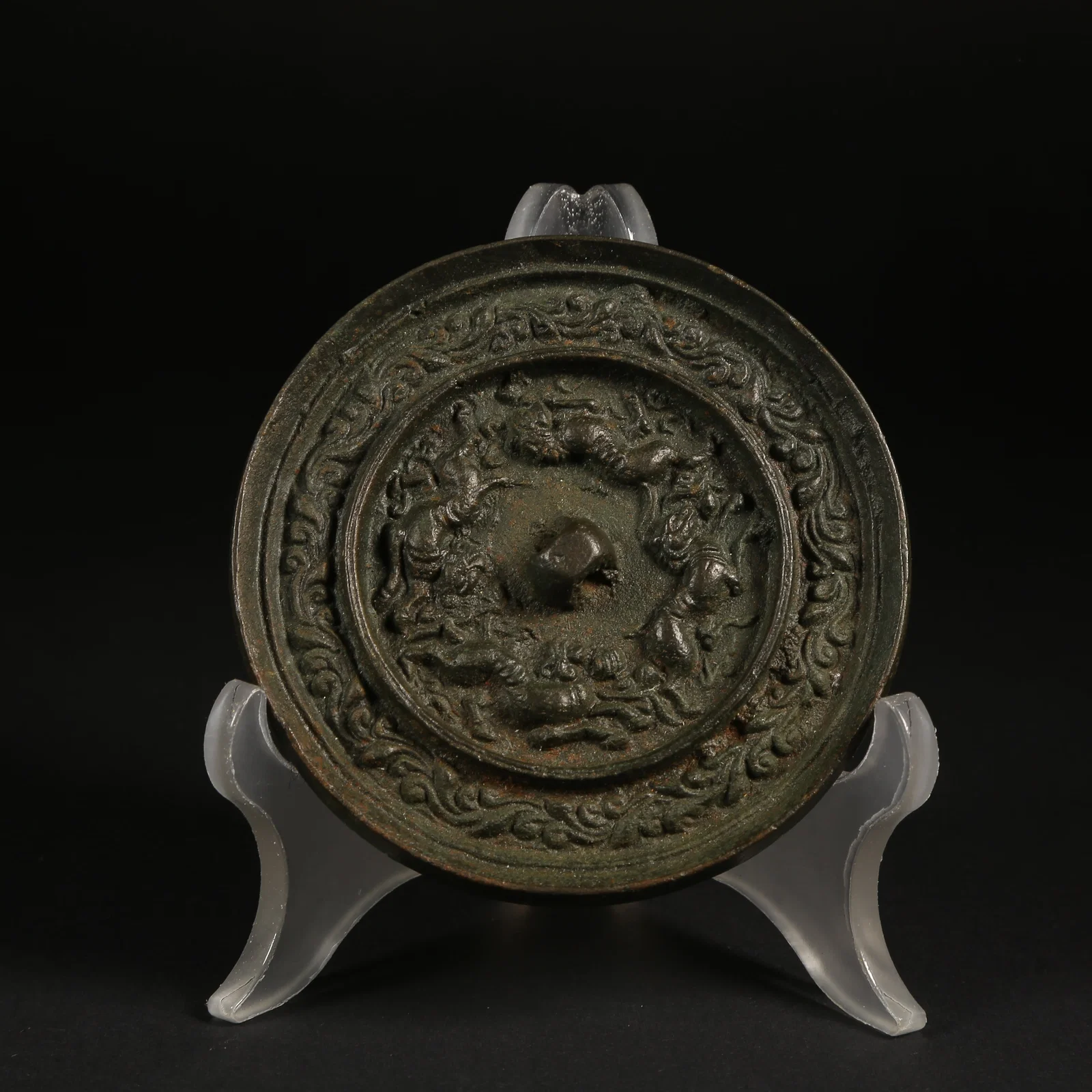 A BRONZE MIRROR WITH RUNNING BEAST AND BRANCHING FLORAL PATTERN