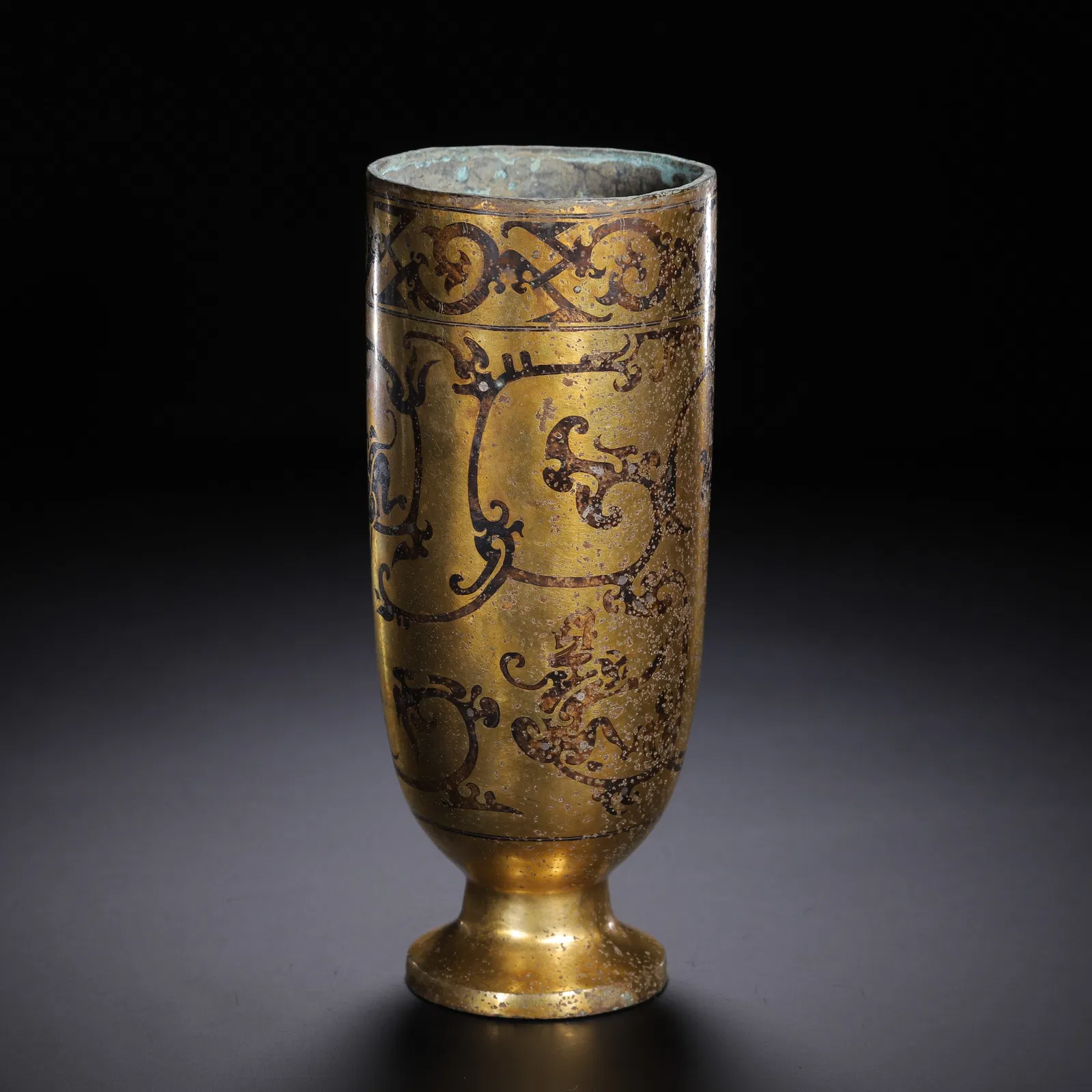 A BRONZE PARTLY GILT CUP