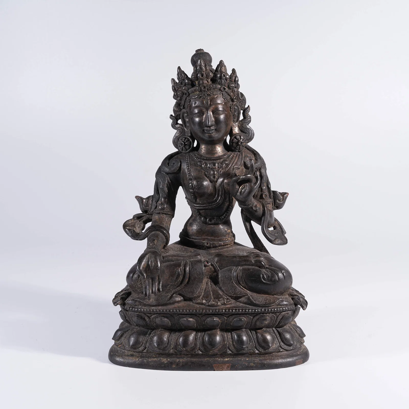 A BRONZE SEATED GUANYIN