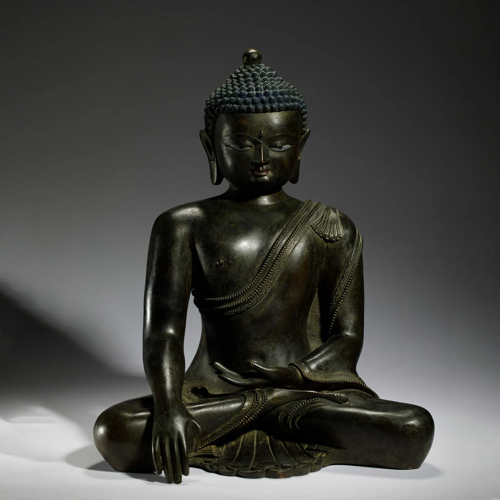 A BRONZE SEATED SHAKYAMUNI