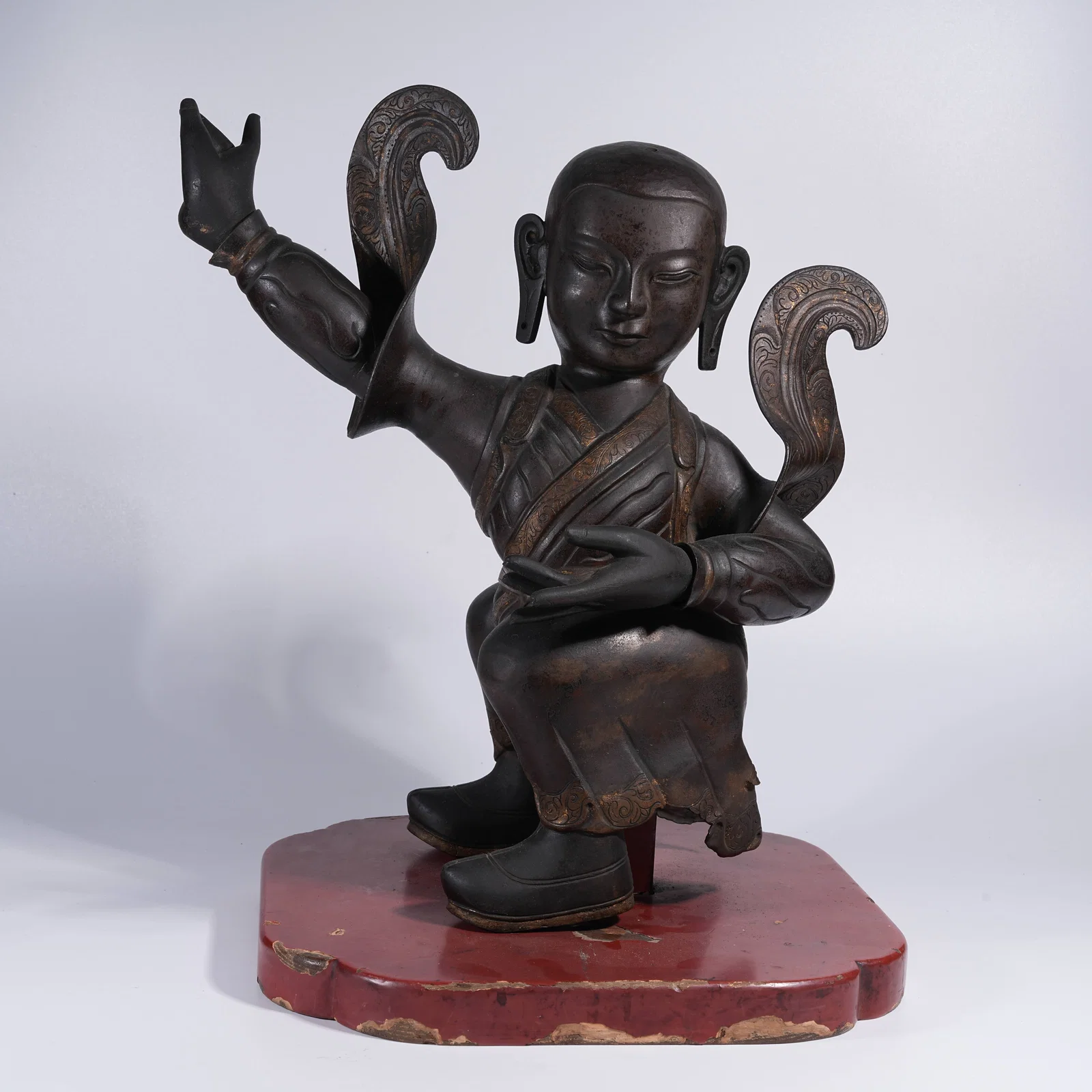 A BRONZE STANDING GOD OF WEALTH WITH EIGHT HORSES