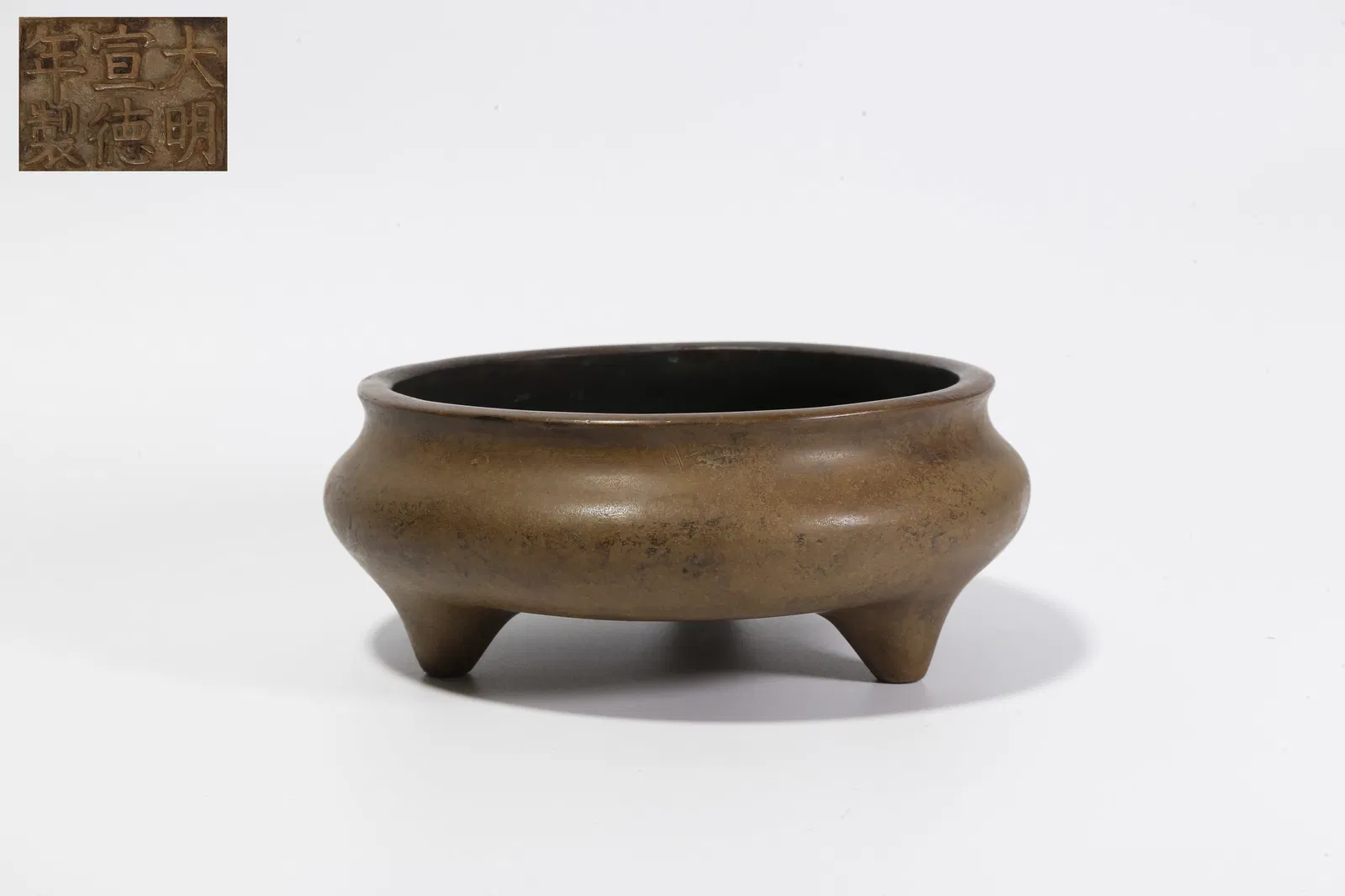 A BRONZE THREE-LEGGED INCENSE BURNER