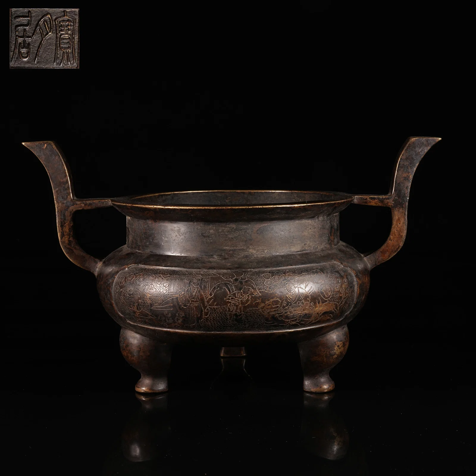 A BRONZE TRIPOD CENSER WITH UPRIGHT LOOP HANDLES AND FIGURAL NARRATIVE DECORATION