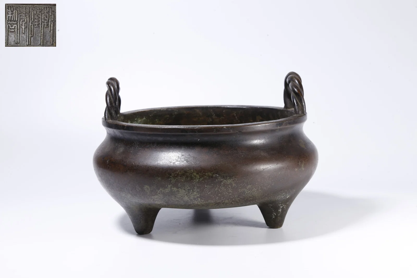 A BRONZE TRIPOD INCENSE BURNER WITH DOUBLE BRIDGE HANDLES