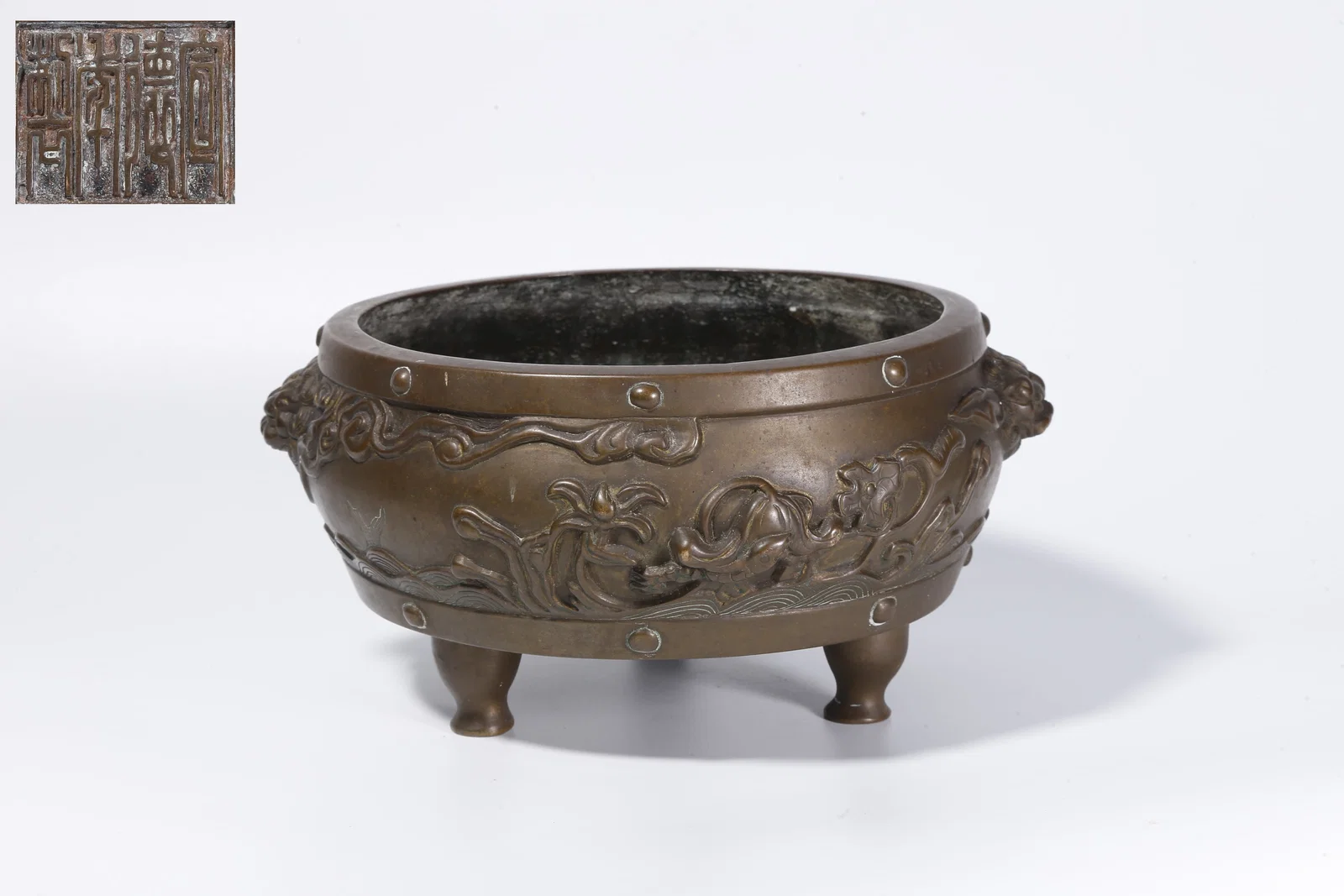 A BRONZE TRIPOD INCENSE BURNER WITH TWIN BEAST HANDLES