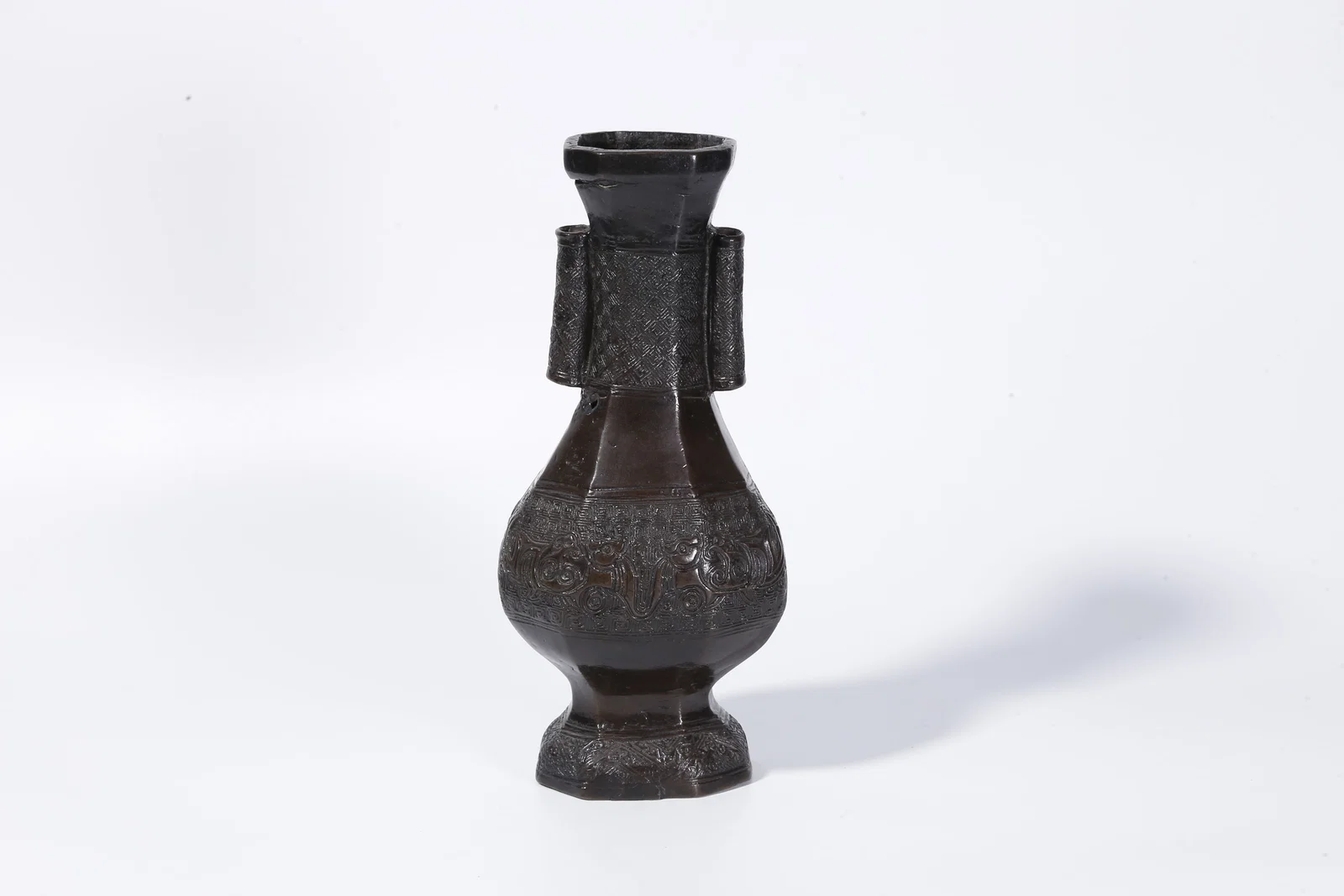 A BRONZE VASE WITH BEAST MOTIF AND TWIN RING HANDLES