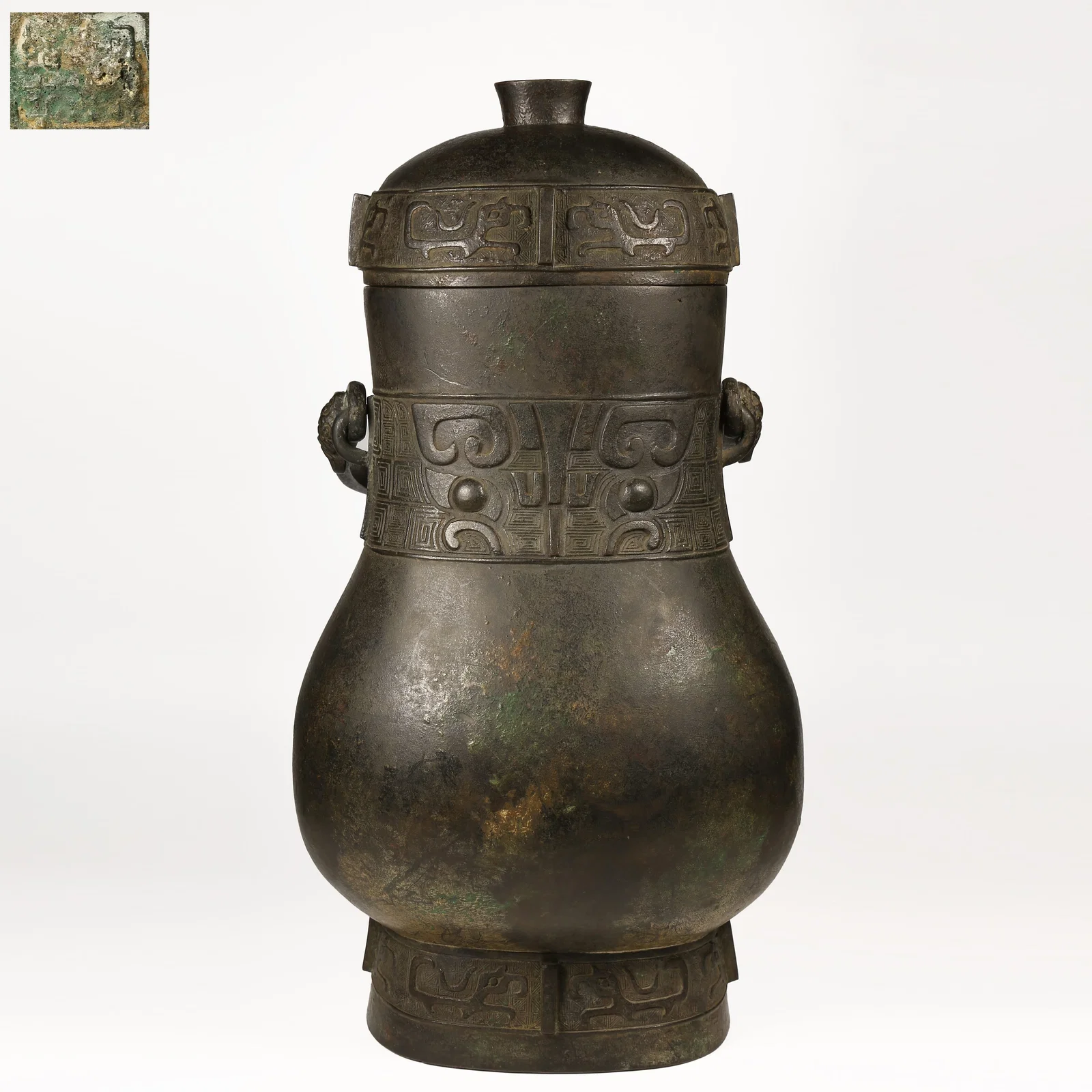 A BRONZE YOU VESSEL WITH ANIMAL-FACE MOTIFS AND UPRIGHT FINIALS
