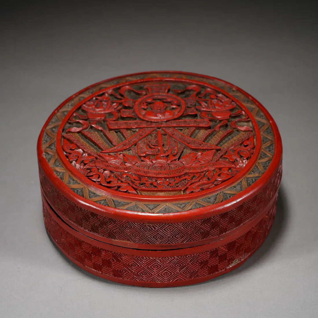 A CARVED CINNABAR LACQUER BOX WITH COVER