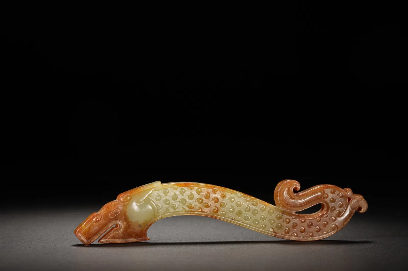 A CARVED JADE DRAGON ORNAMENT