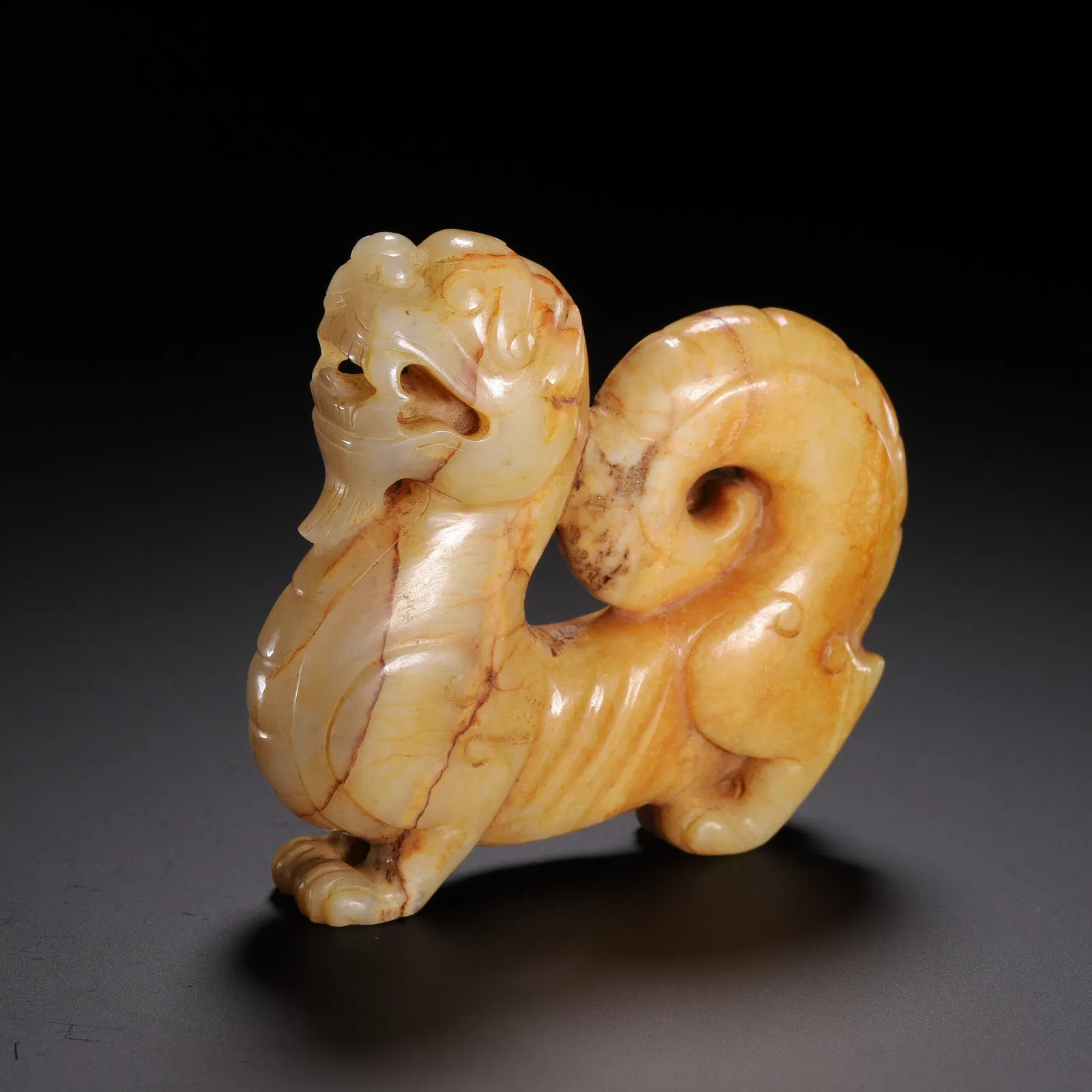A CARVED JADE MYTHICAL BEAST