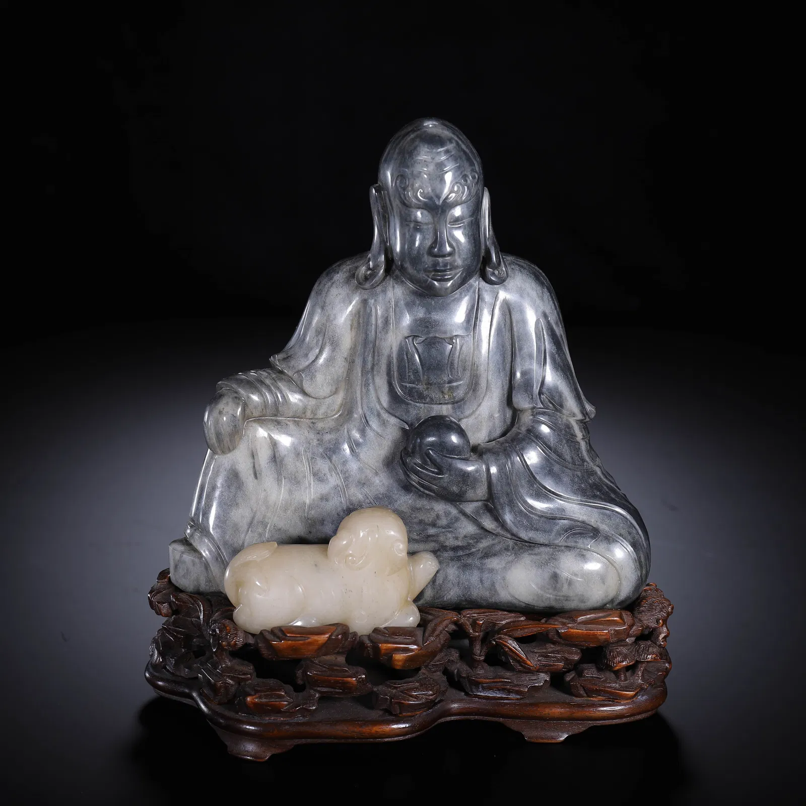 A CARVED JADE SEATED LUOHAN