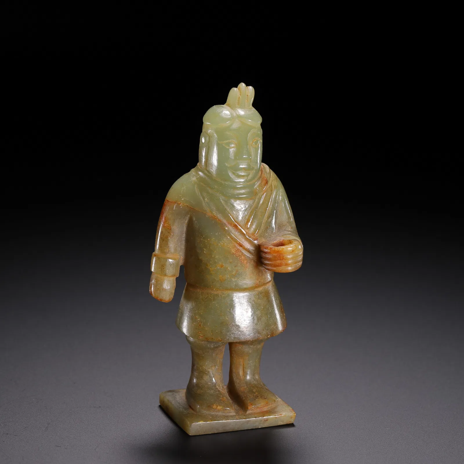 A CARVED JADE STANDING FIGURE