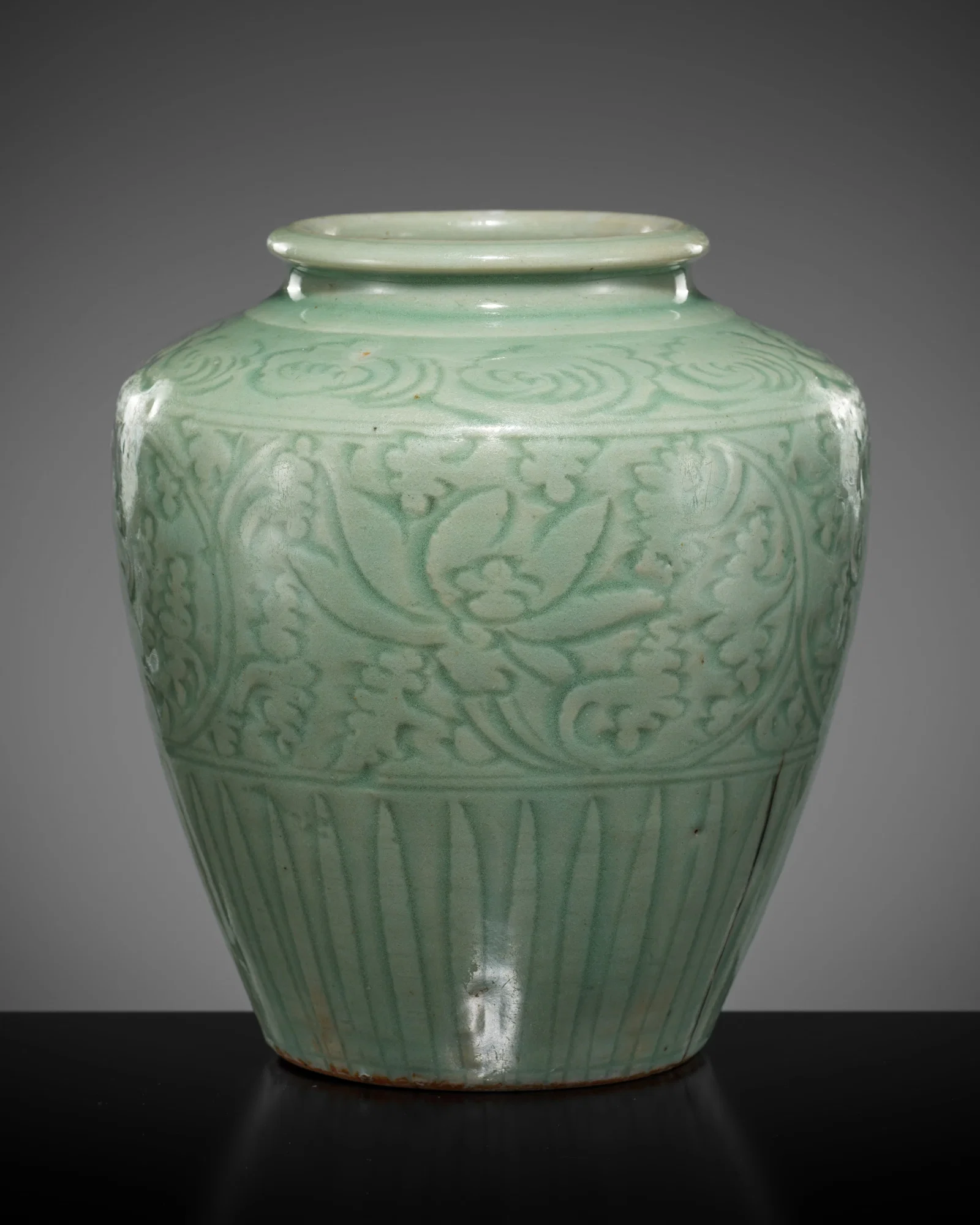 A CARVED LONGQUAN CELADON 'LOTUS' JAR, YUAN TO EARLY MING DYNASTY