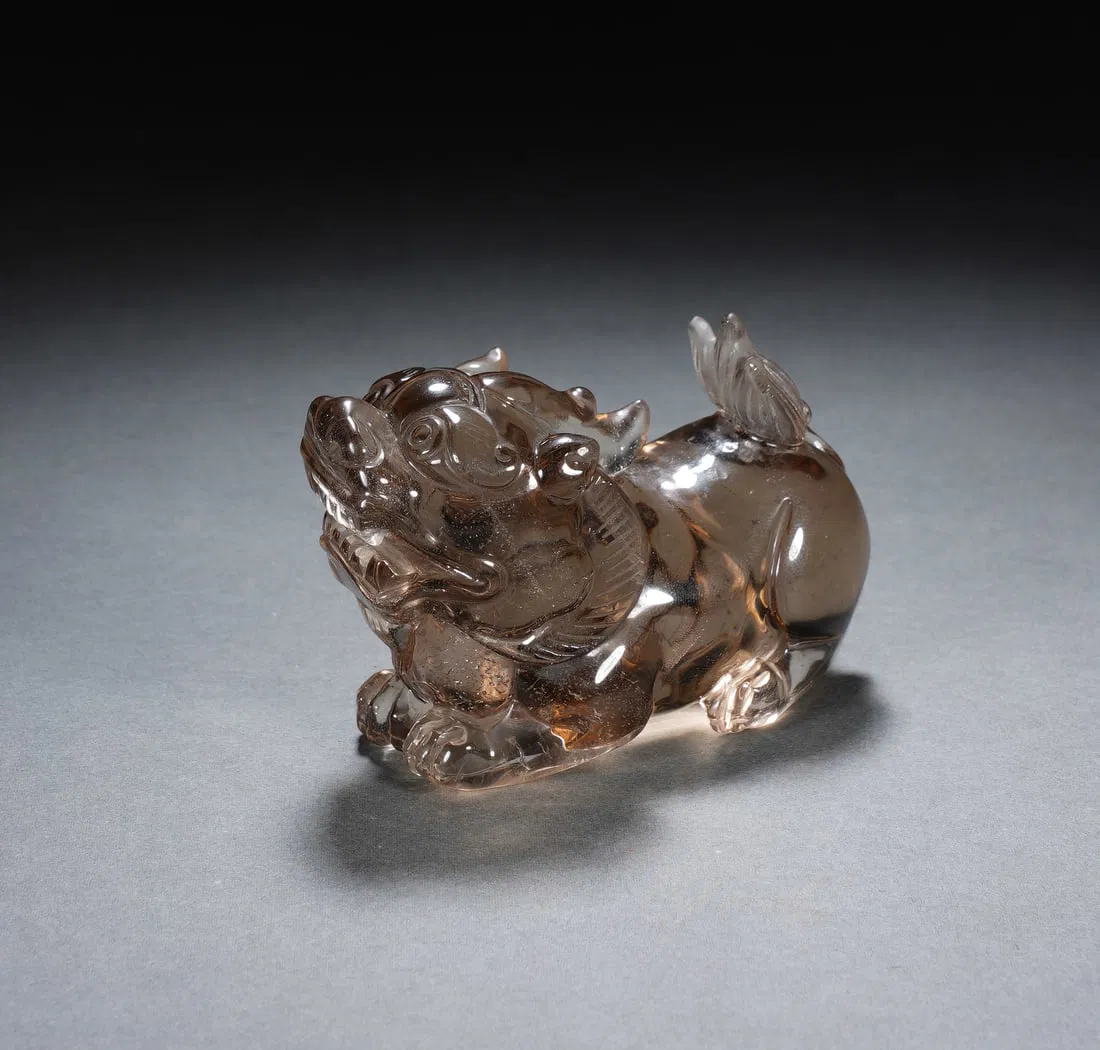 A CARVED SMOKY QUARTZ MYTHICAL BEAST BIXIU