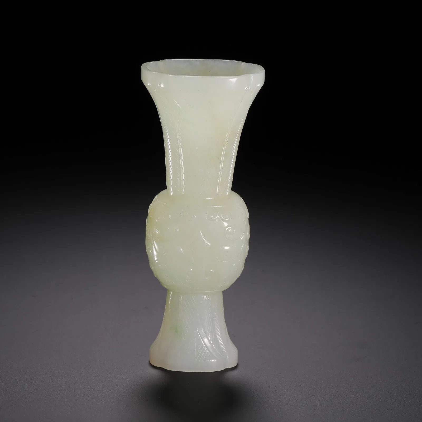 A CARVED WHITE JADE BEAKER VASE GU