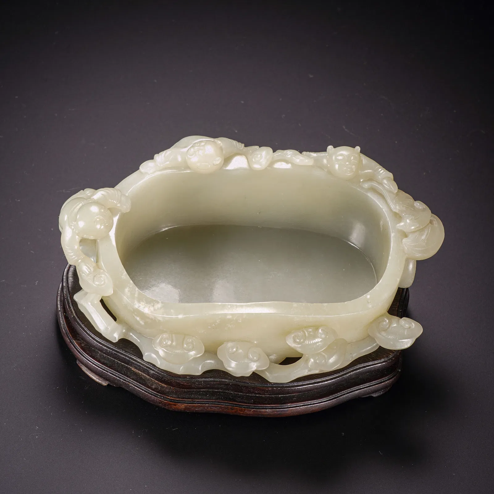 A CARVED WHITE JADE BOYS BRUSH WASHER