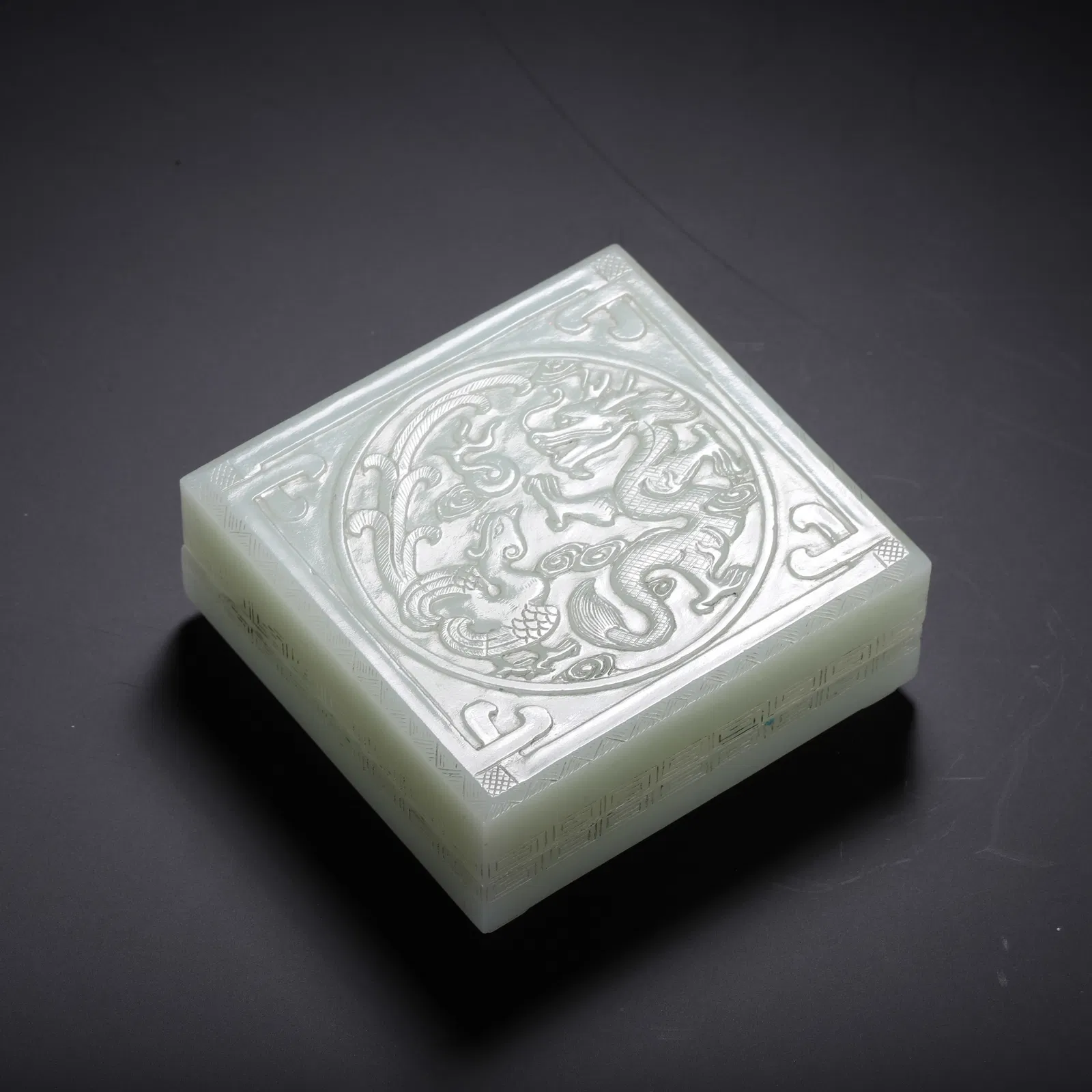 A CARVED WHITE JADE DRAGON BOX WITH COVER