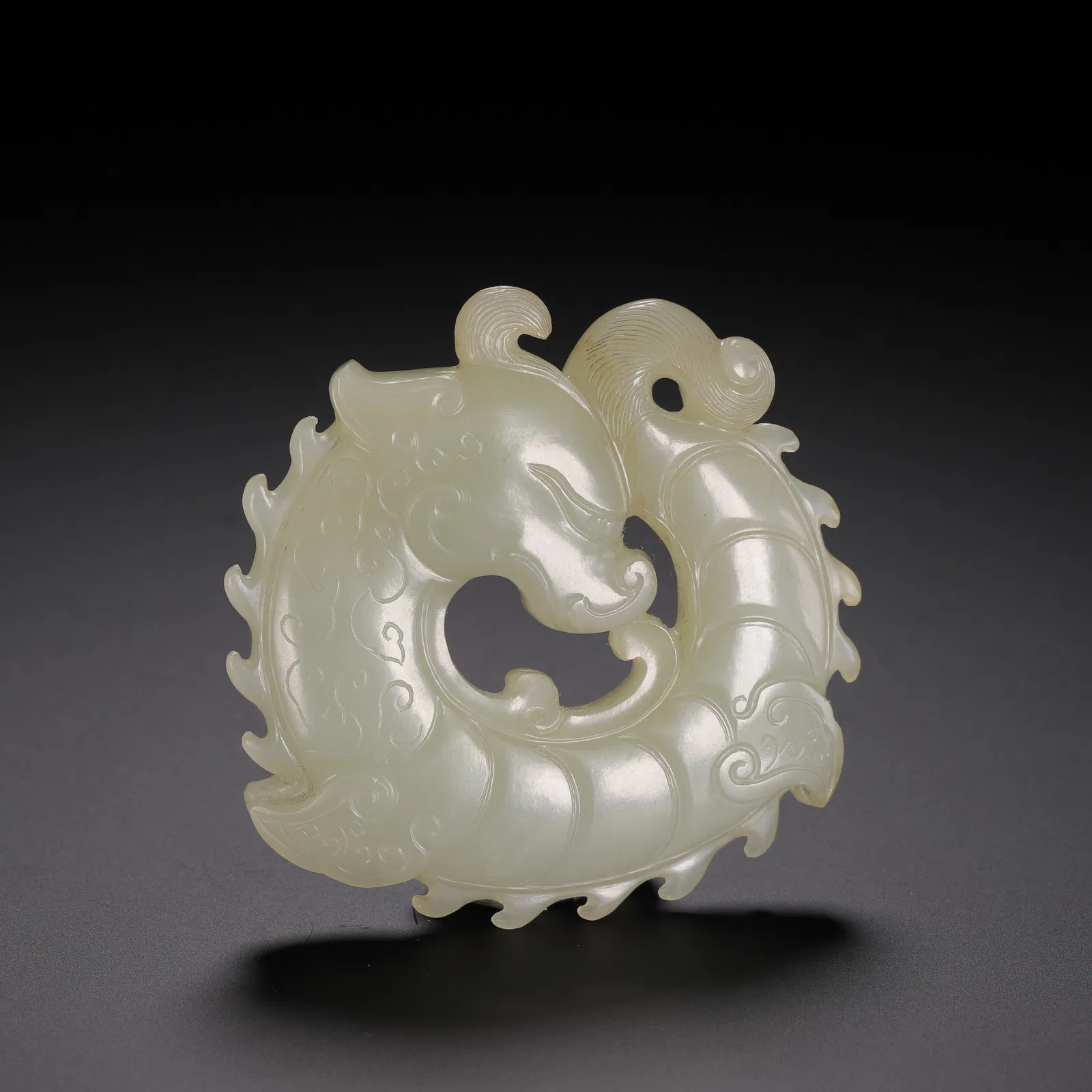 A CARVED WHITE JADE DRAGON