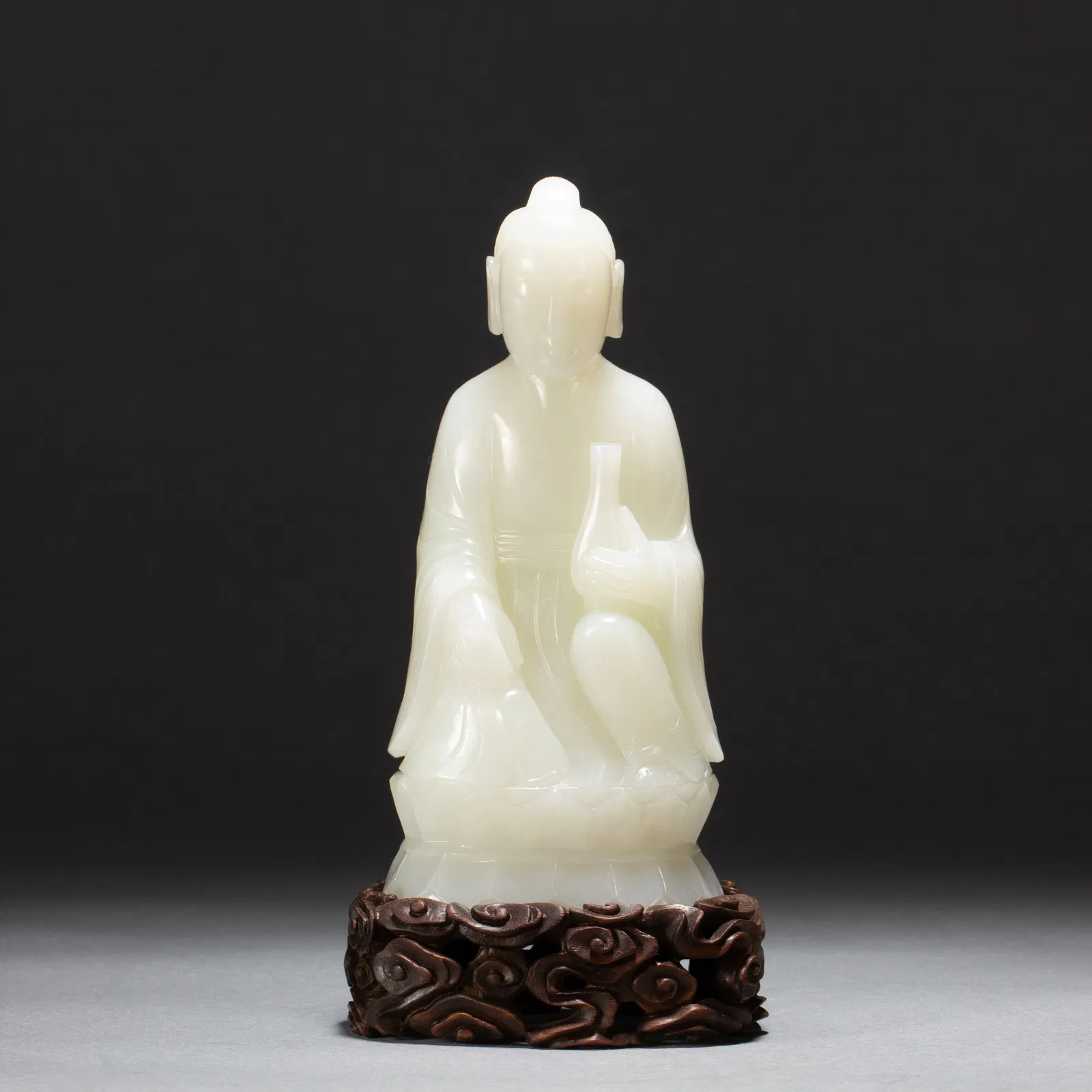 A CARVED WHITE JADE FIGURE
