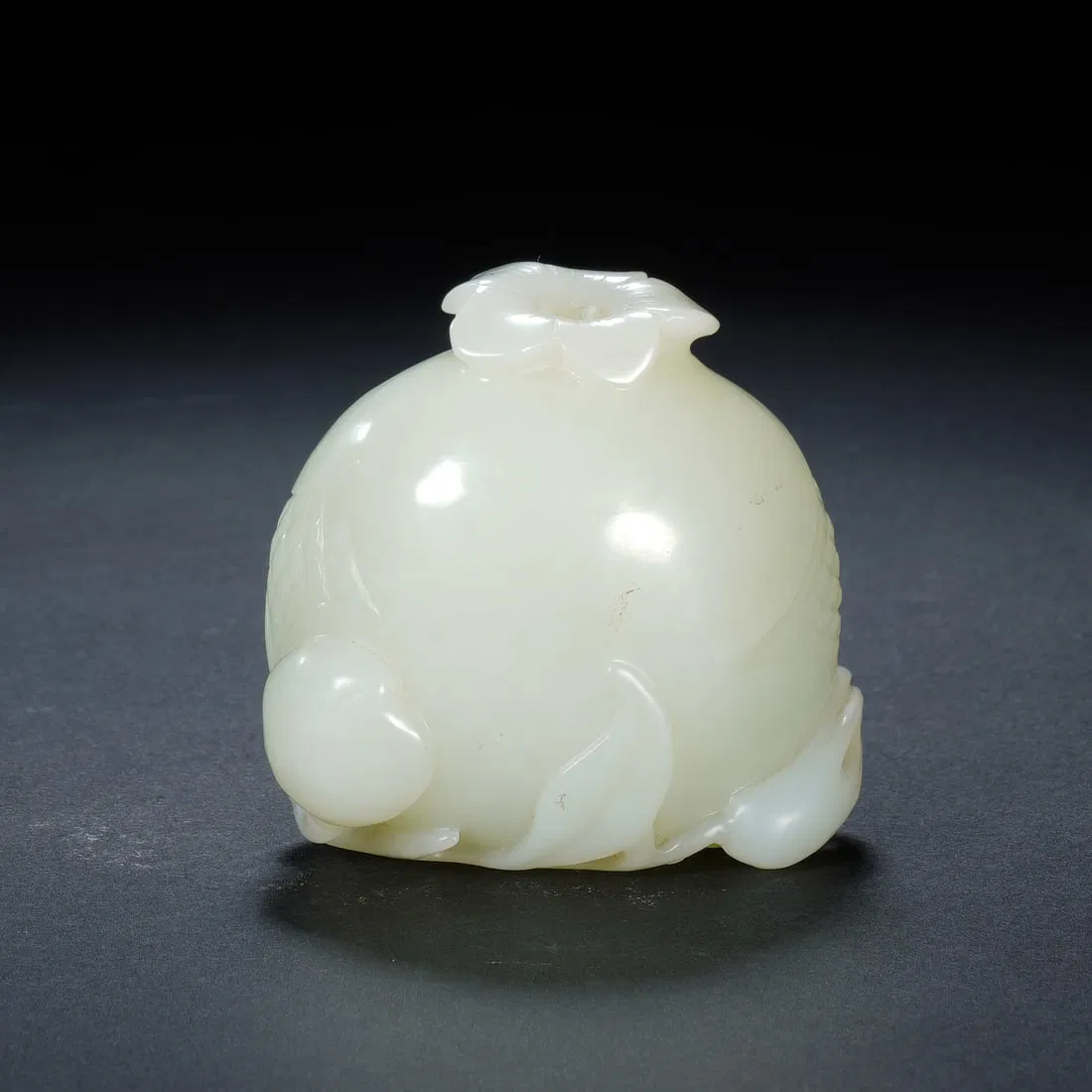 A CARVED WHITE JADE POMGRANATE
