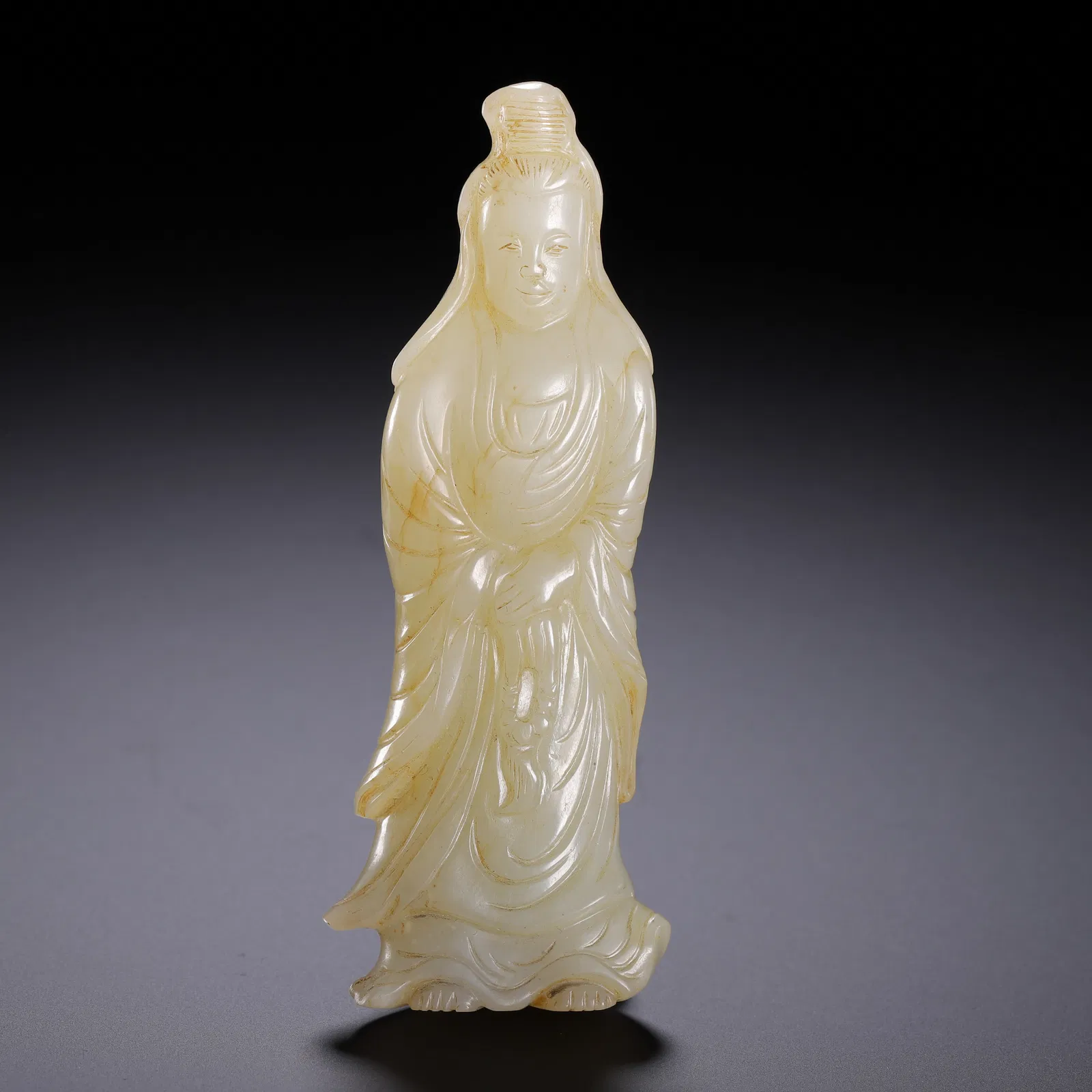 A CARVED WHITE JADE STANDING GUANYIN