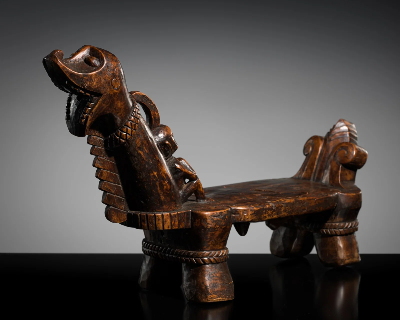 A CARVED WOOD CEREMONIAL COCONUT SCRAPER, ONO NIHA PEOPLE, SOUTHERN NIAS ISLAND