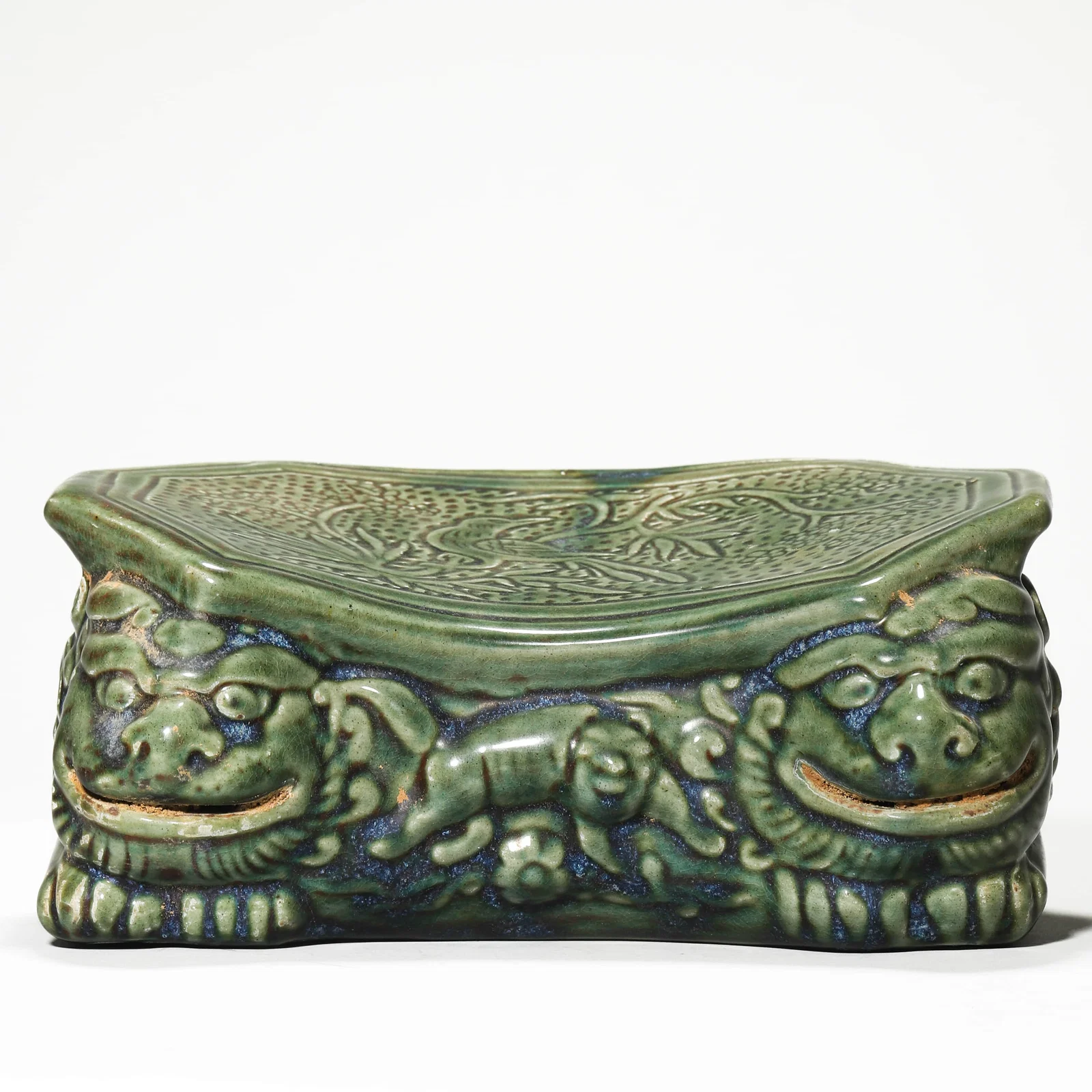 A CELADON-GLAZED PILLOW.