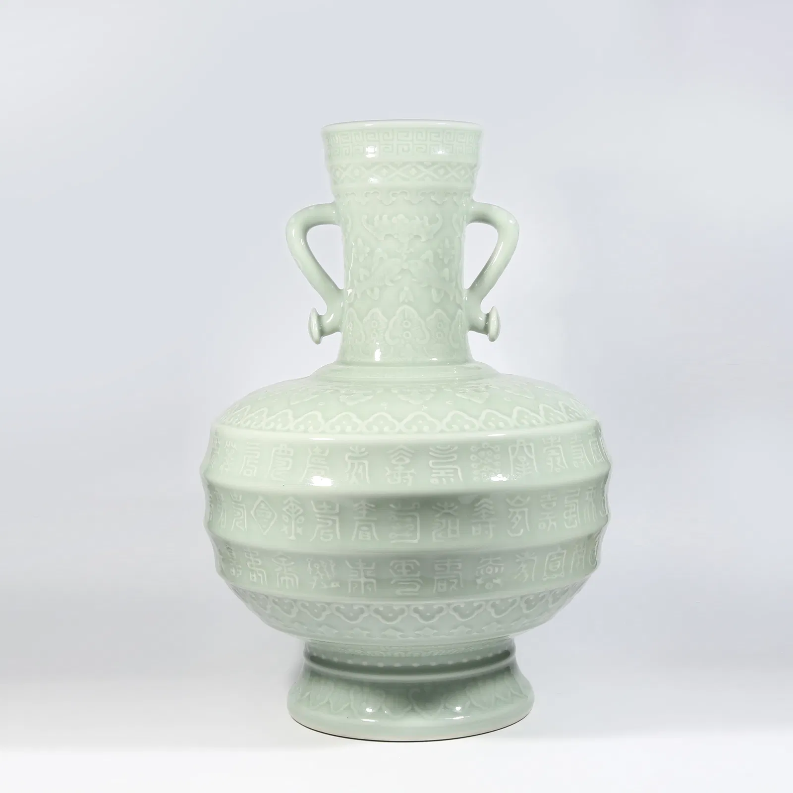 A CELADON-GLAZED RUYI-EAR VASE WITH LONGEVITY STRING PATTERN