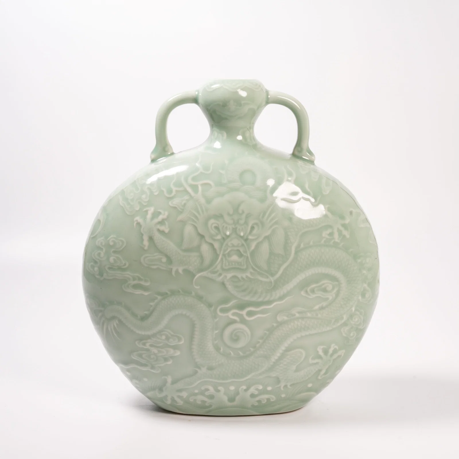 A CELADON-GLAZED VASE WITH CLOUD-AND-DRAGON DESIGN AND RIBBON HANDLES