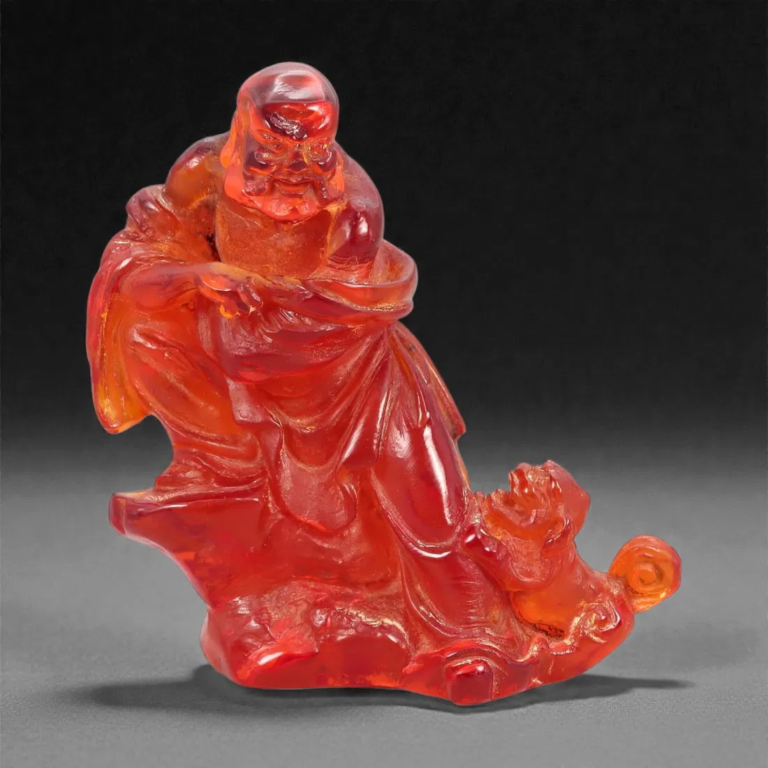 A Chinese Amber-Resin Figure of a Luohan, 20th Century, 40FH