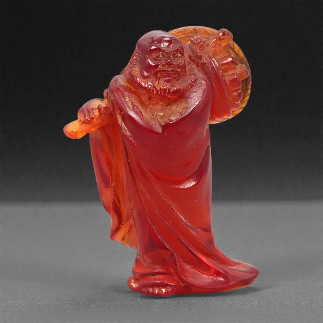 A Chinese Amber-Resin Figure of a Luohan, 20th Century, 41FH