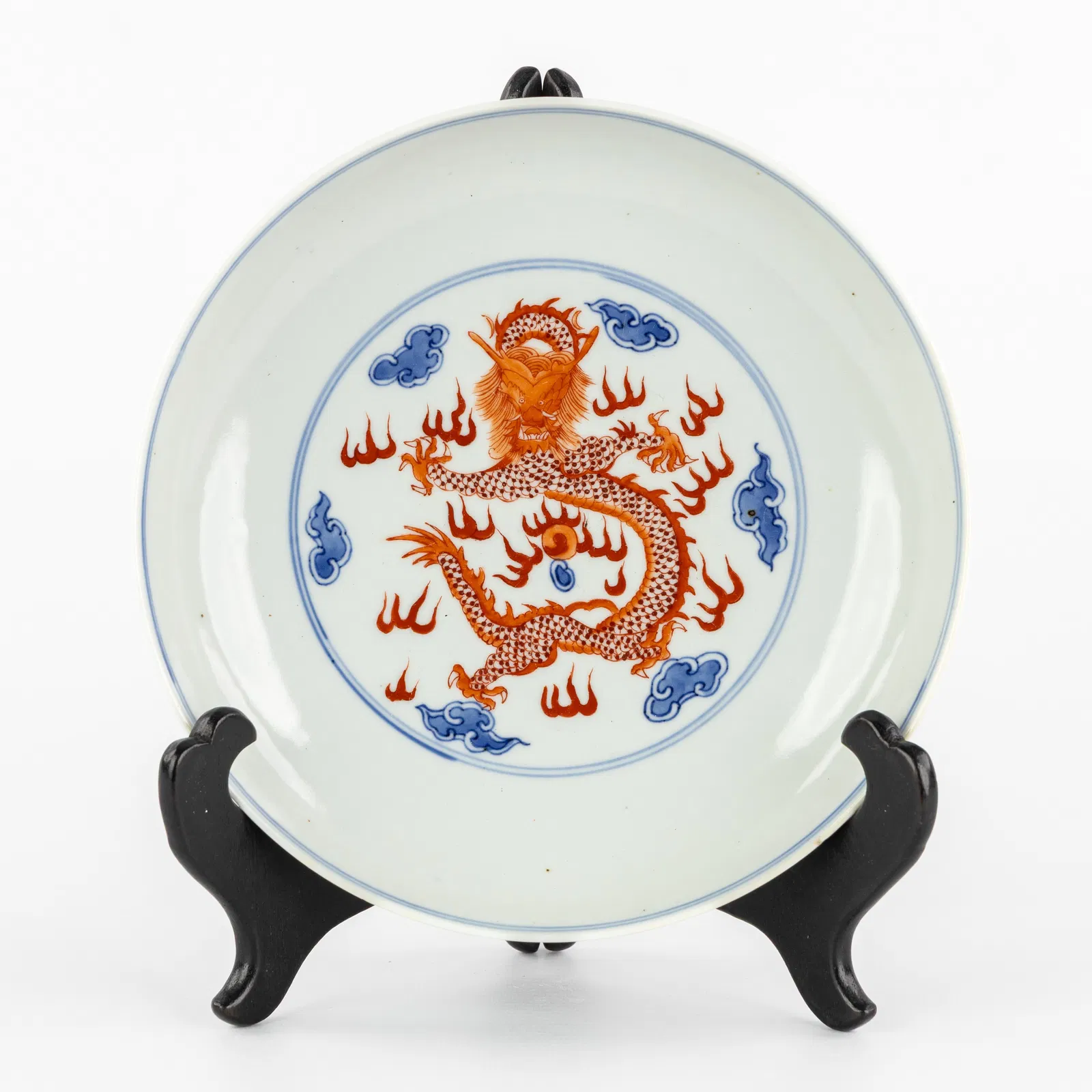 A Chinese blue and white plate with iron-red dragon decoration, marked Qianlong.