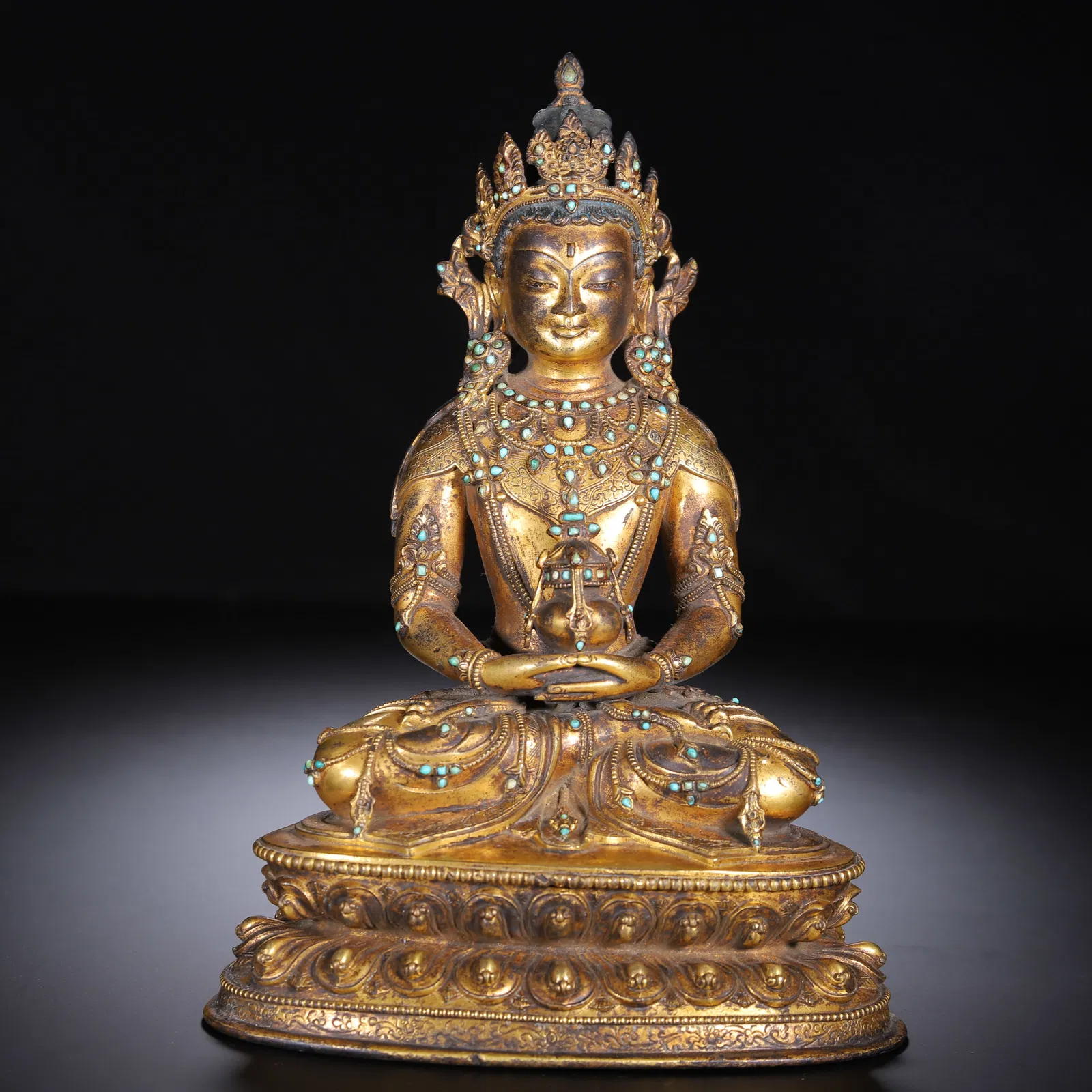 A CHINESE GILT-BRONZE BUDDHA FIGURE WITH INLAID GEMSTONES