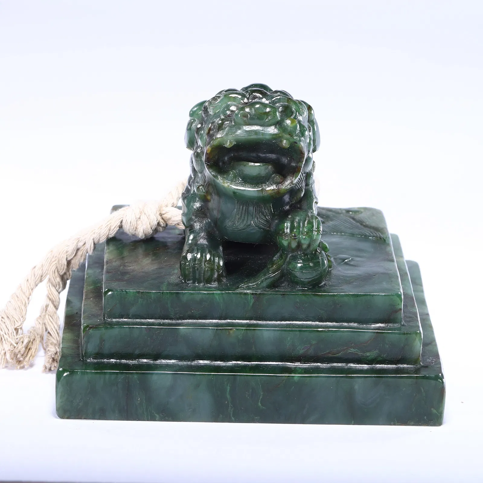 A CHINESE HETIAN SPINACH JADE SEAL WITH LION KNOP