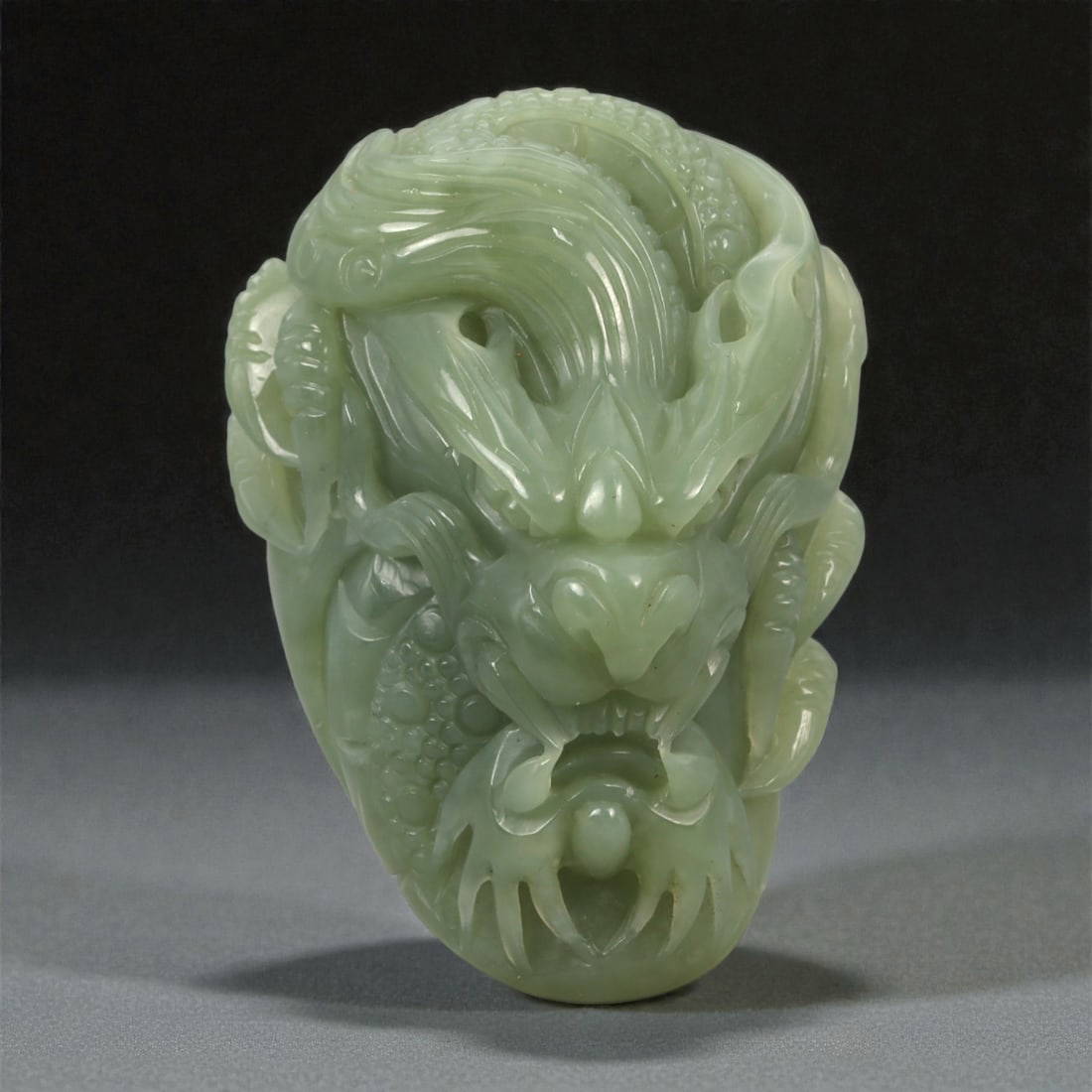 A Chinese Jade Dragon Mask Pendant, 20th Century, 54YA