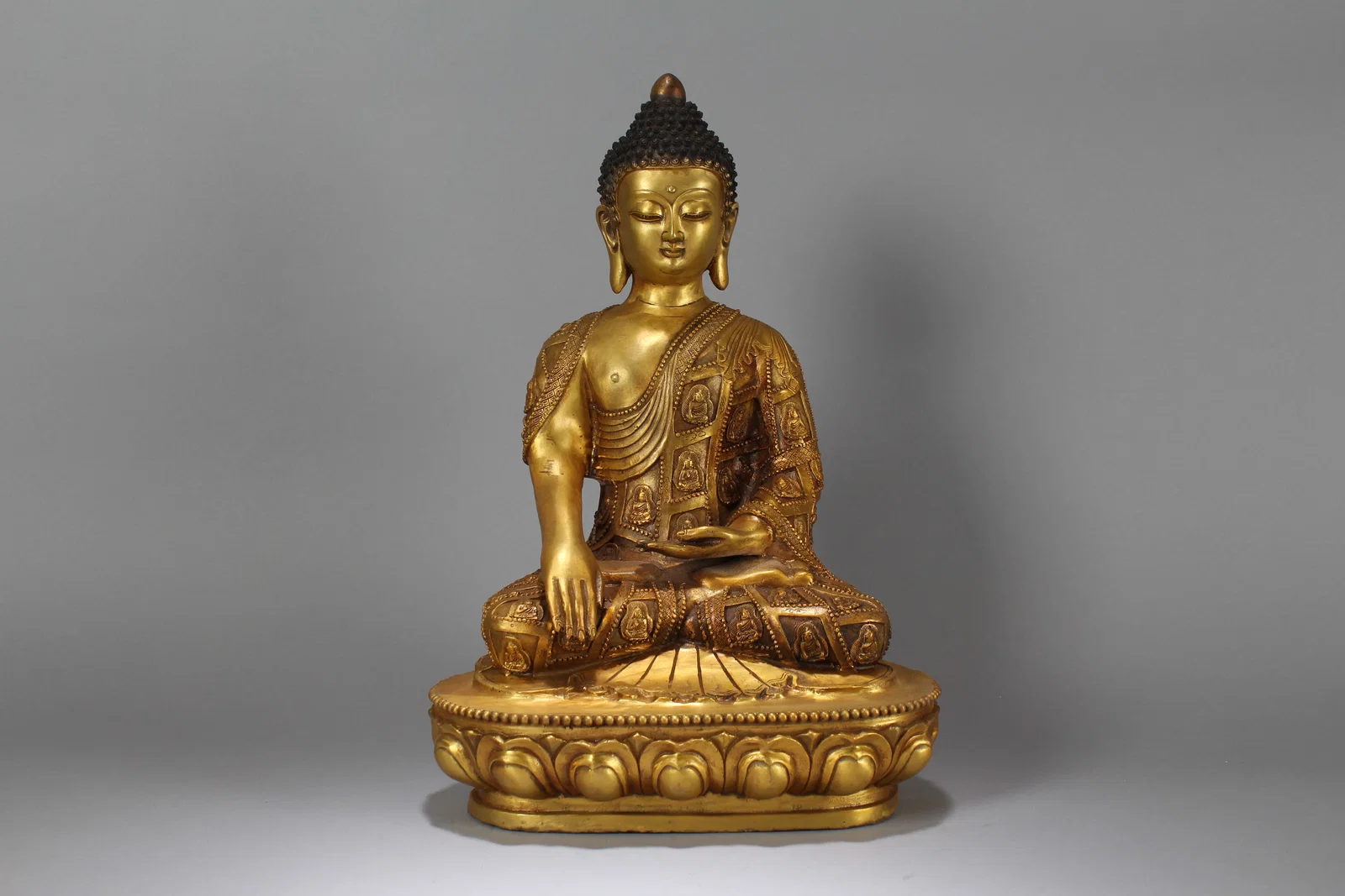 A Chinese Lotus-seated Gilt Fortune Buddha Statue