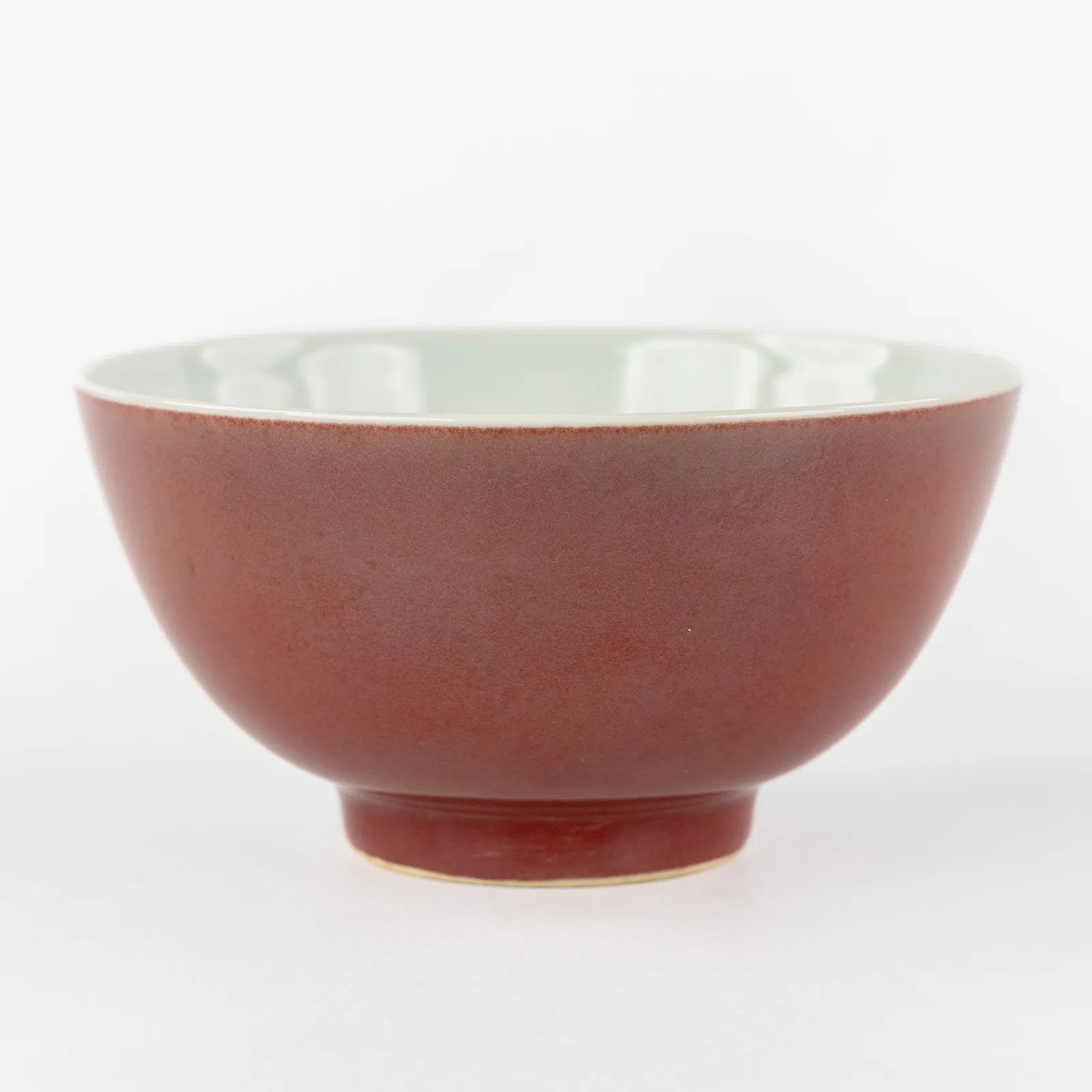 A Chinese monochrome Liver-Red or Sang De Boeuf wine bowl, marked Qianlong.