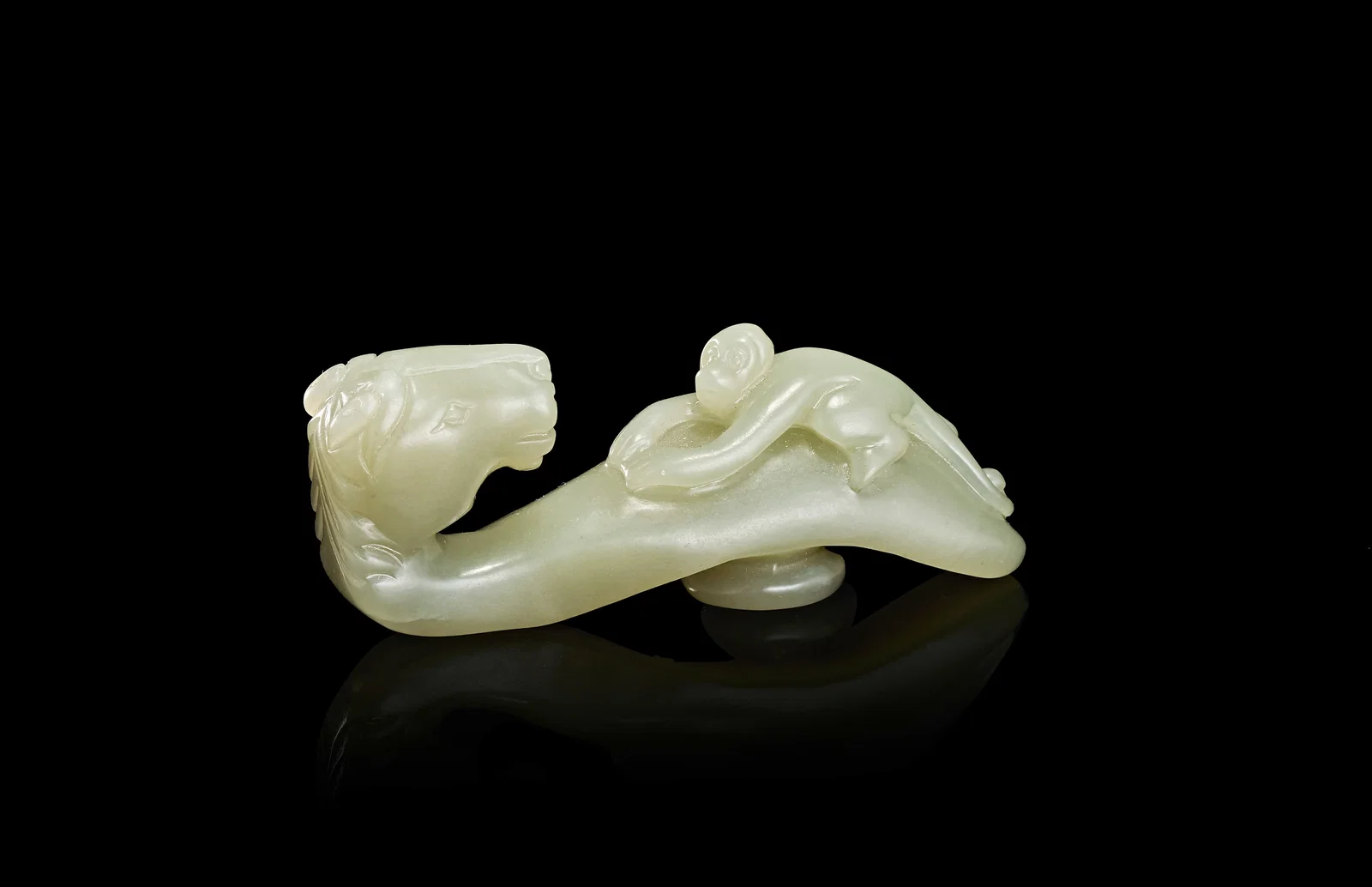 A CHINESE PALE CELADON JADE HORSE AND MONKEY BELT HOOK, QING DYNASTY (1644-1911)