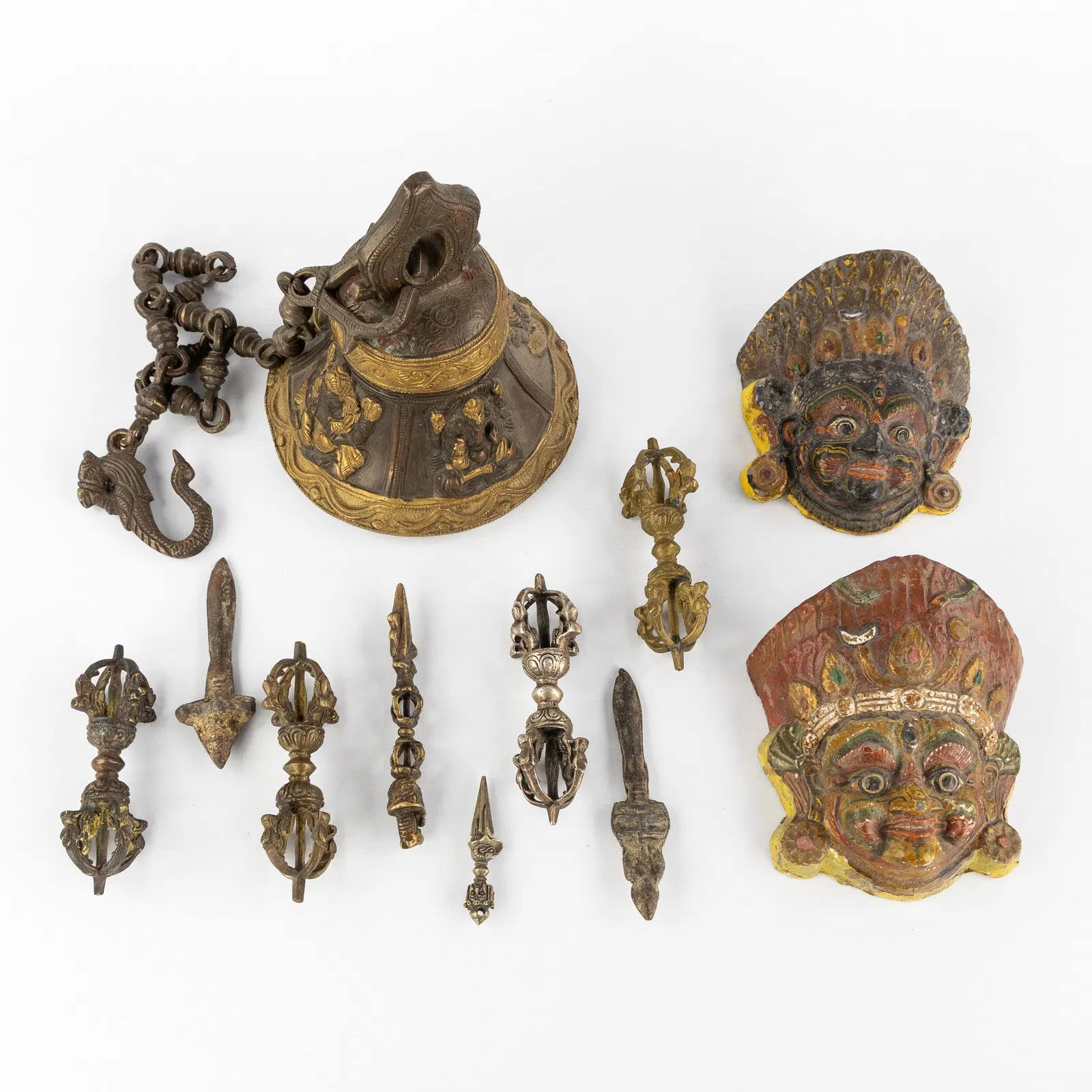 A Collection of 11 Tibetan Ritual Accessories, Vajra, Dorje, Phurba, temple bell and masks.